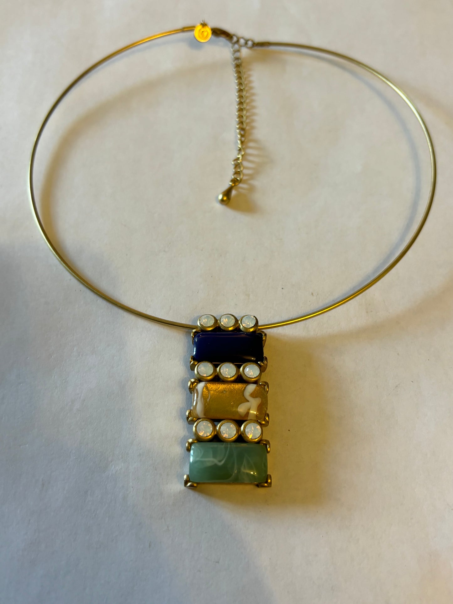 Solid gold metal necklace with blue and green sliding pendant