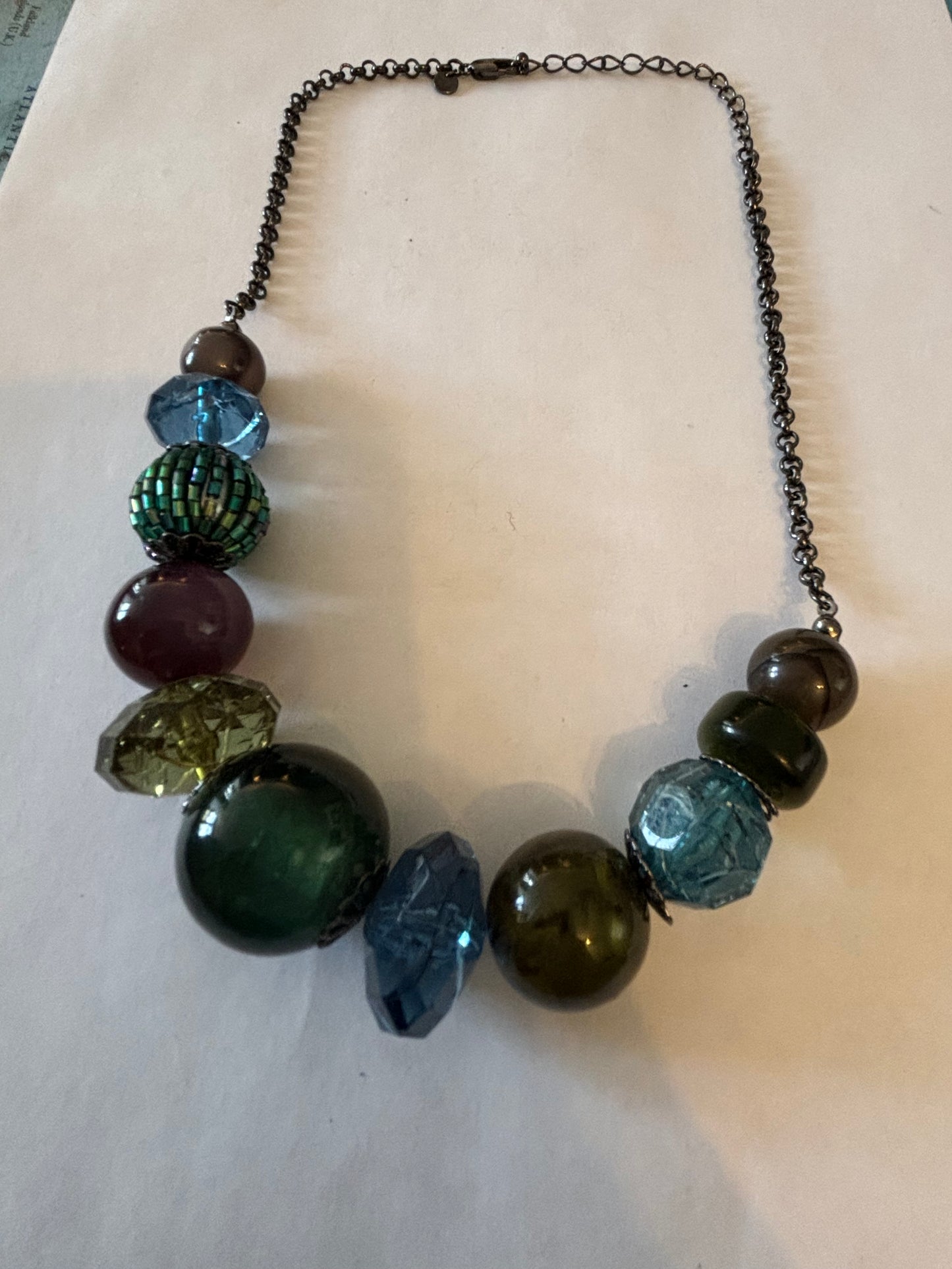 Dark metal necklace with varied dark blue green and purple beads