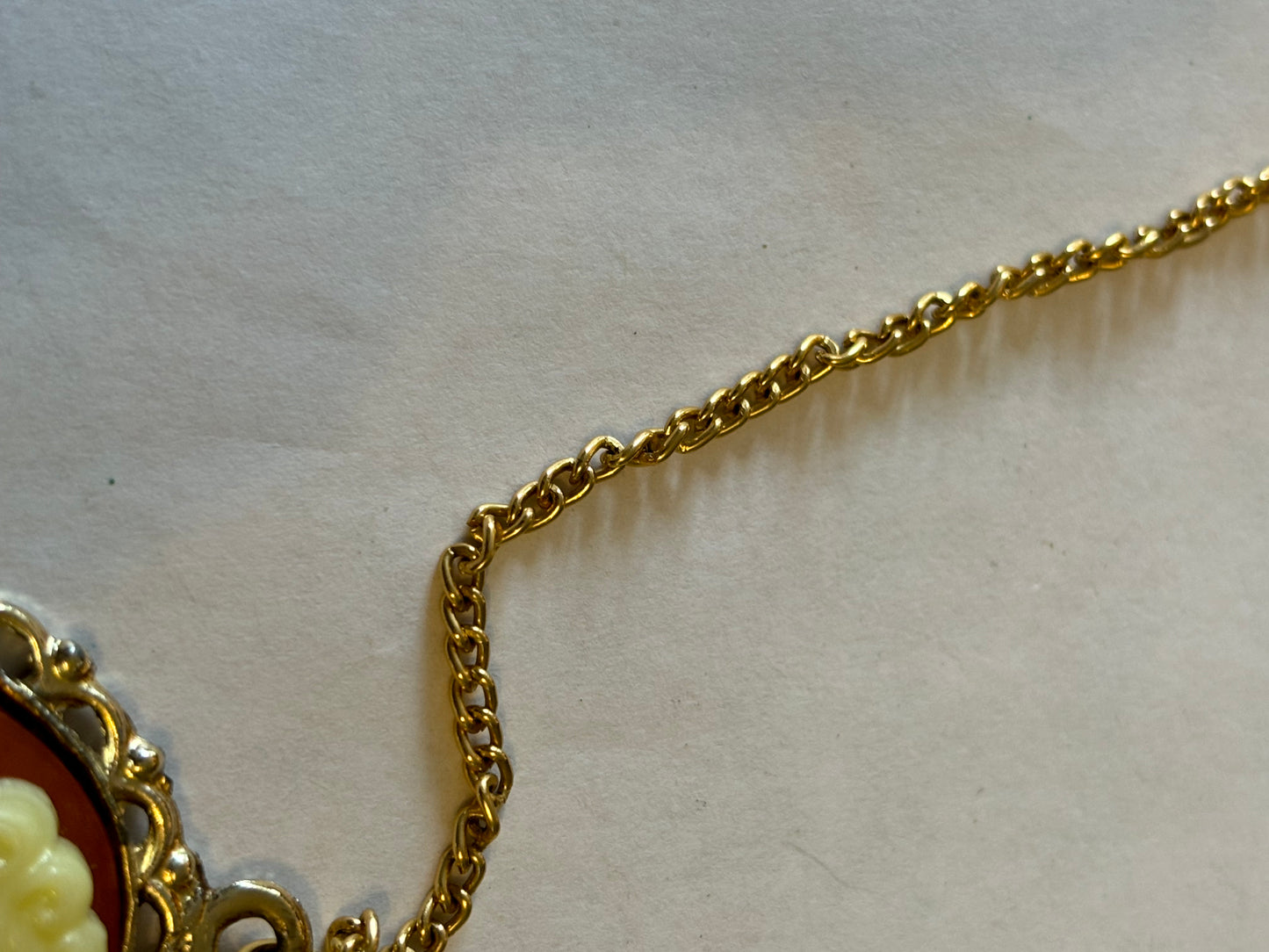 Long gold metal necklace with Cameo pendant