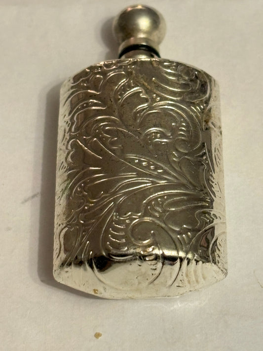 Small silver metal perfume bottle with applicator