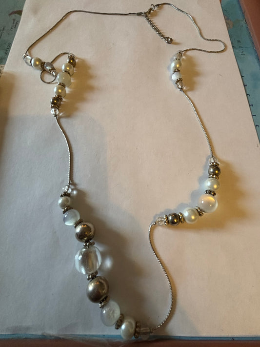 Long silver metal necklace with white, silver and pearlescent grouped beads