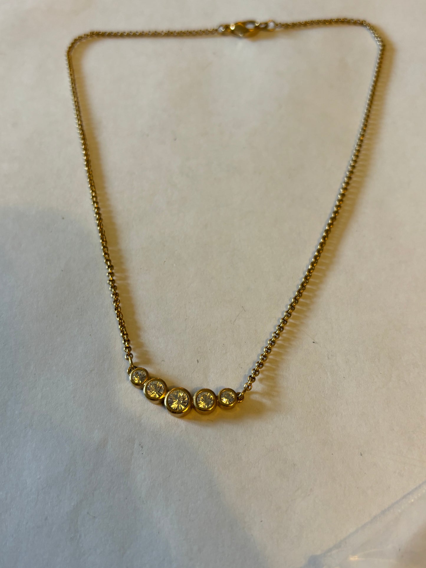 Gold Metal chain necklace with a row of 5 white stones pendant