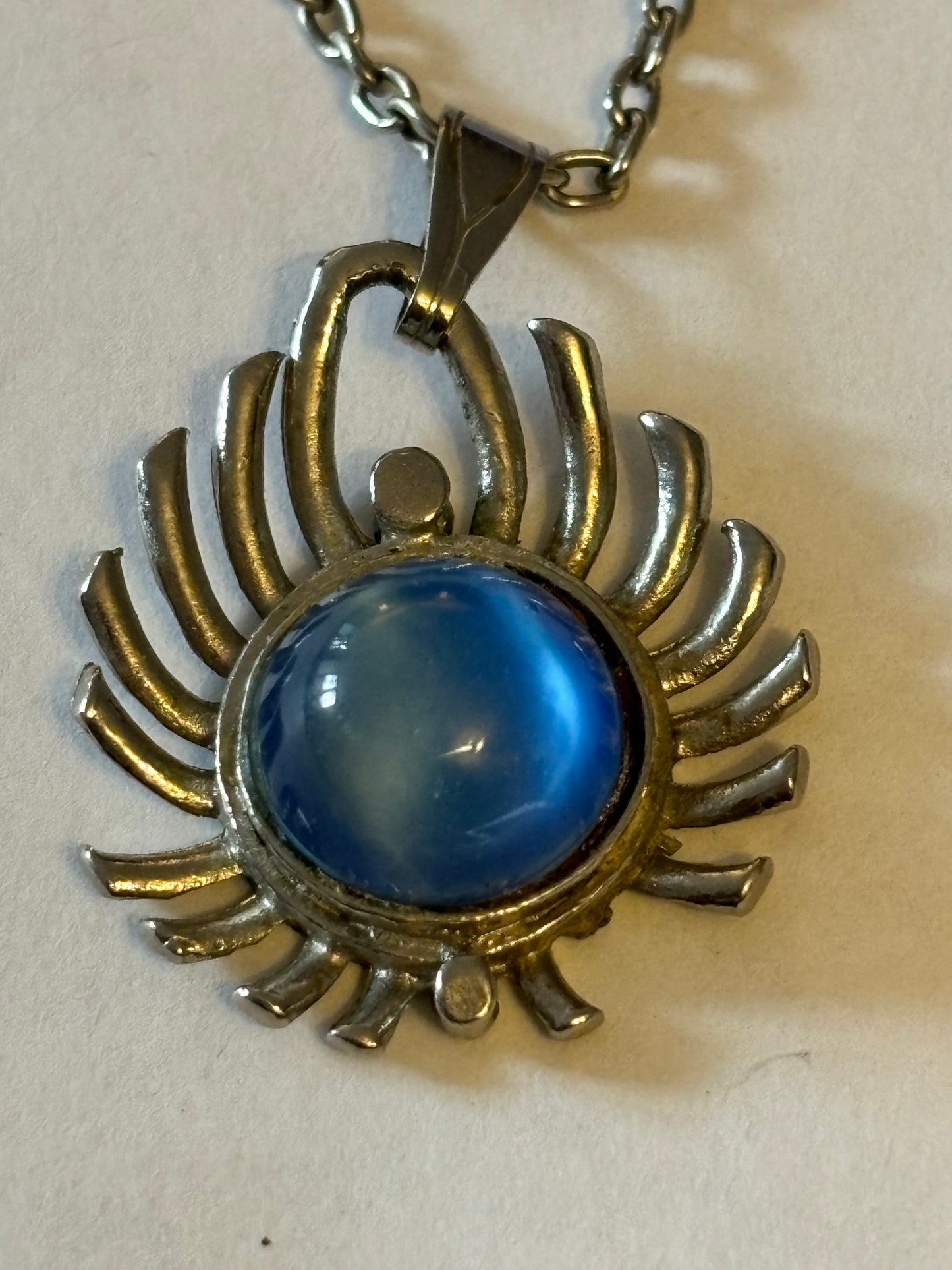 Long silver metal necklace with vivid blue stone pendant