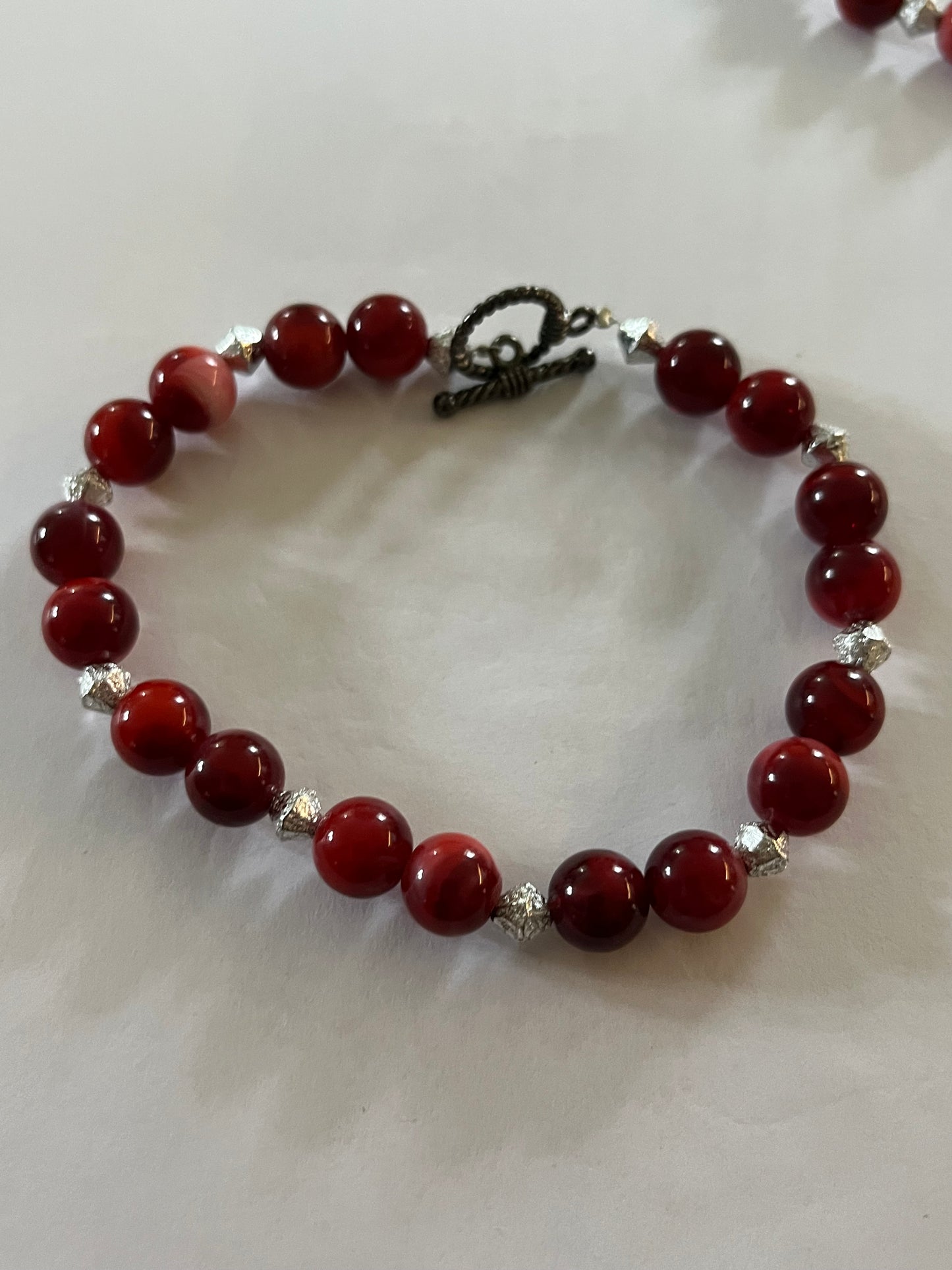 Red marbled bead necklace with silver spacers and matching bracelet