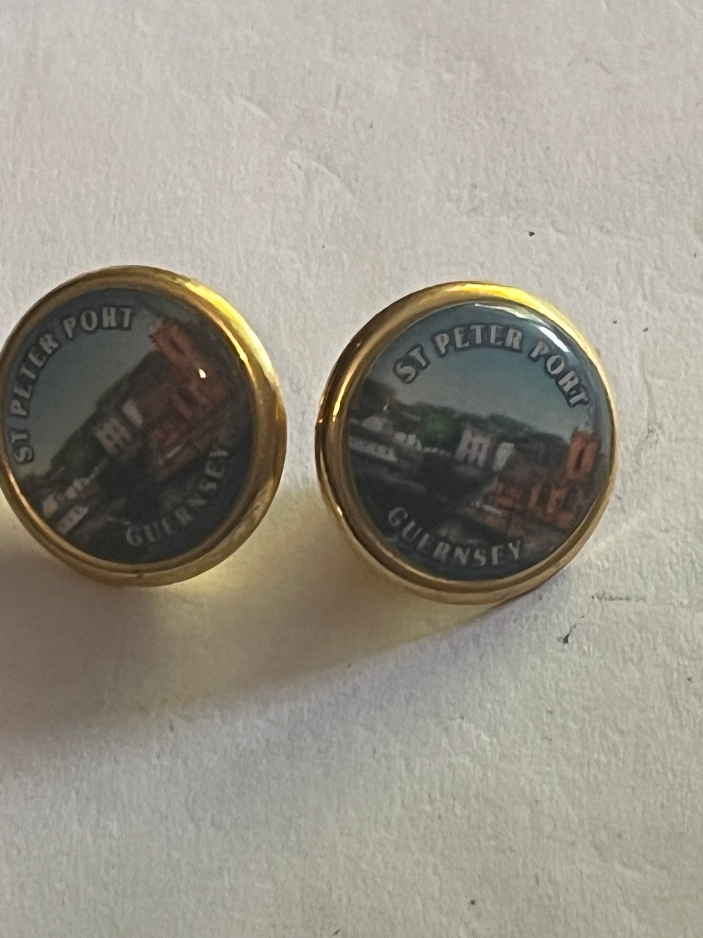 St. Peter Port - Pair of small round gold metal pin badges