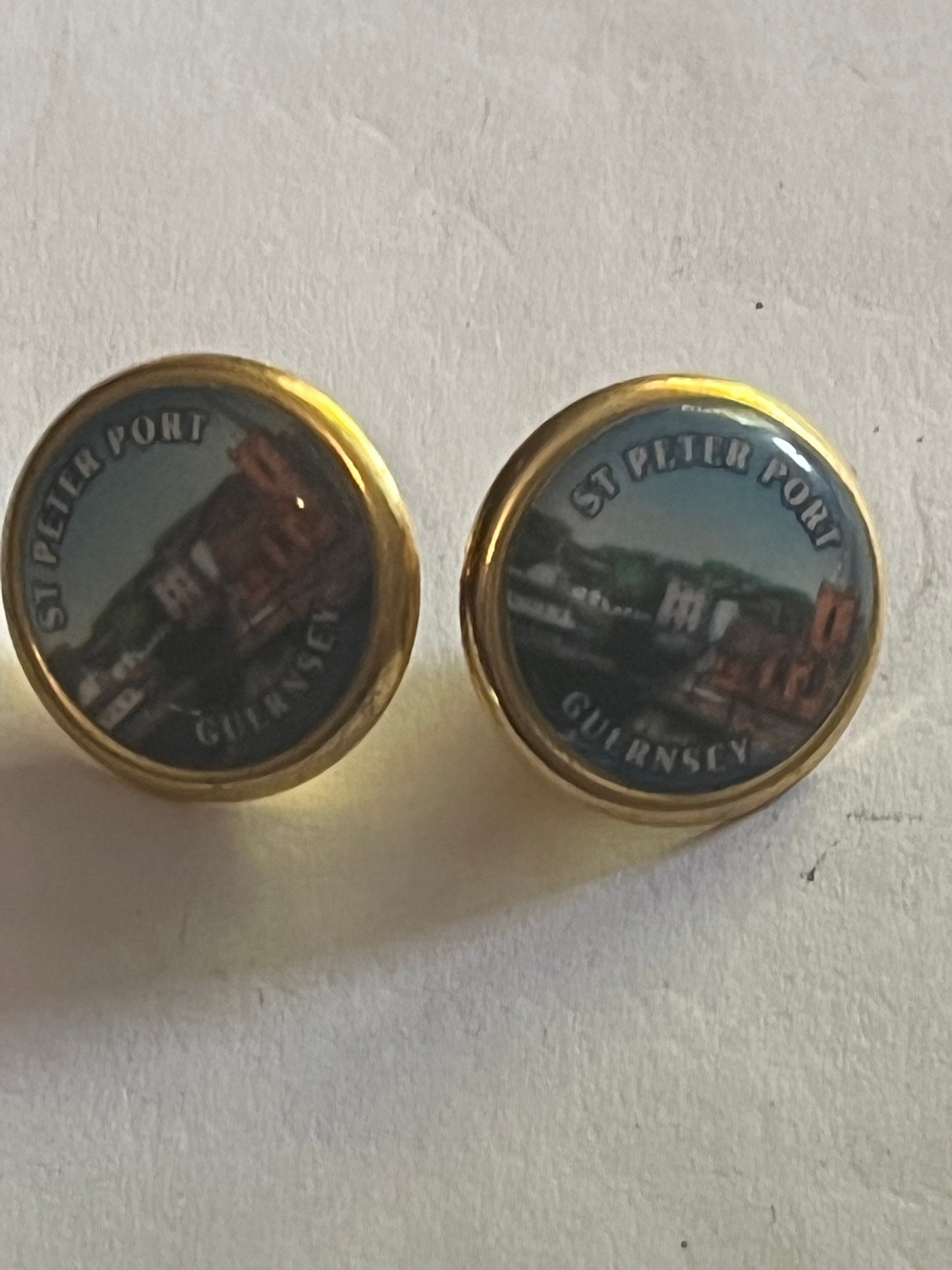 St. Peter Port - Pair of small round gold metal pin badges