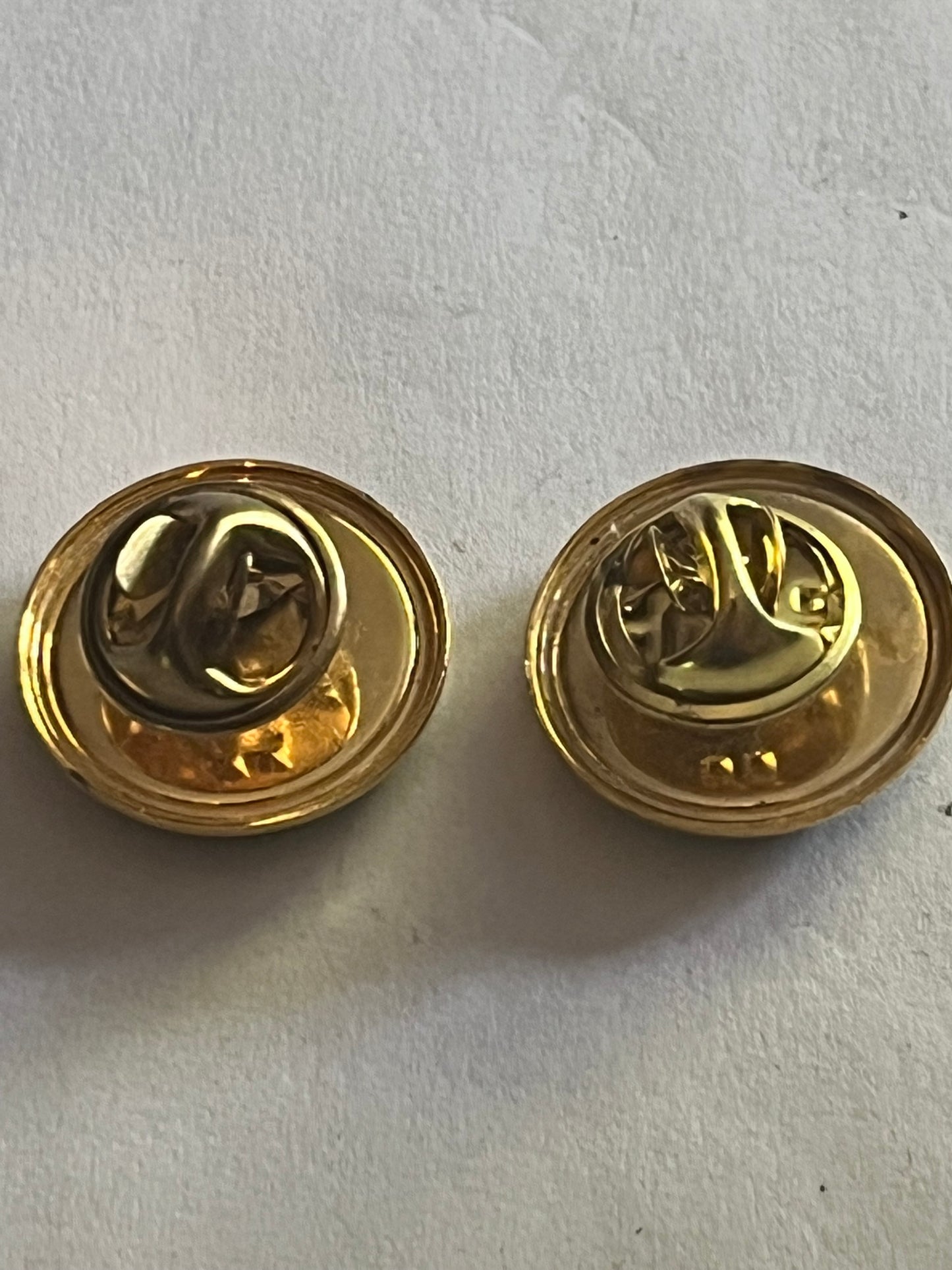 St. Peter Port - Pair of small round gold metal pin badges