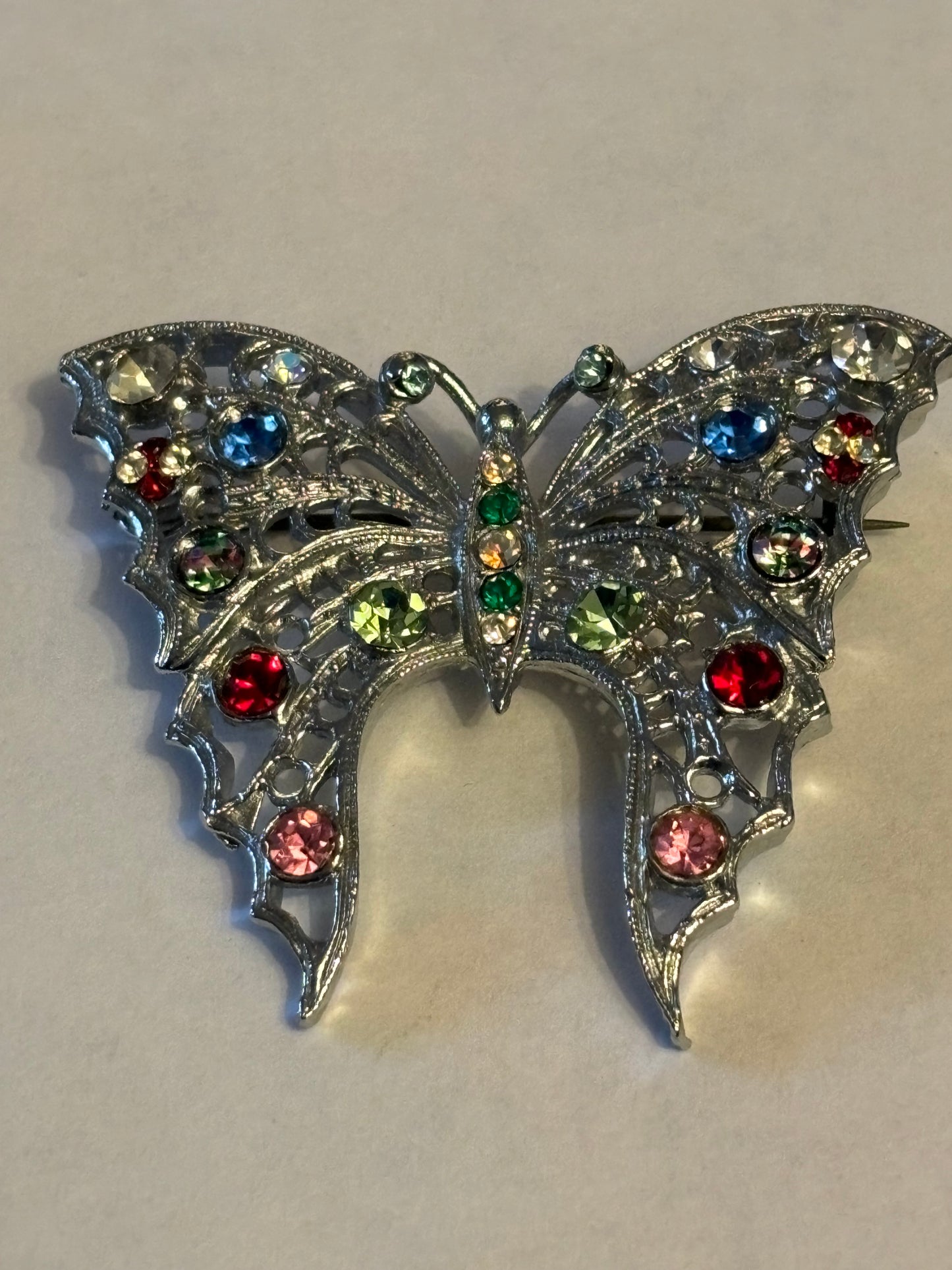 Large bright silver metal butterfly brooch with coloured stones