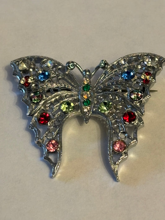 Large bright silver metal butterfly brooch with coloured stones