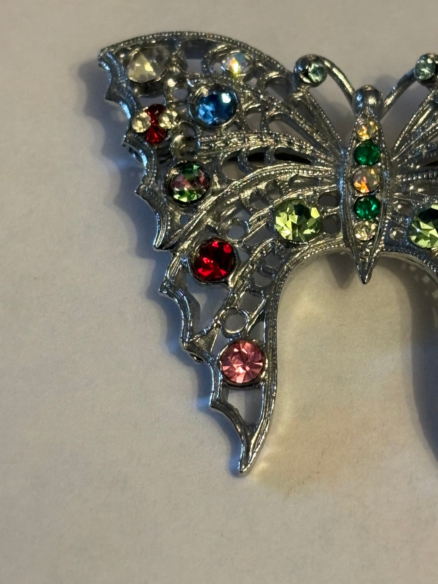 Large bright silver metal butterfly brooch with coloured stones