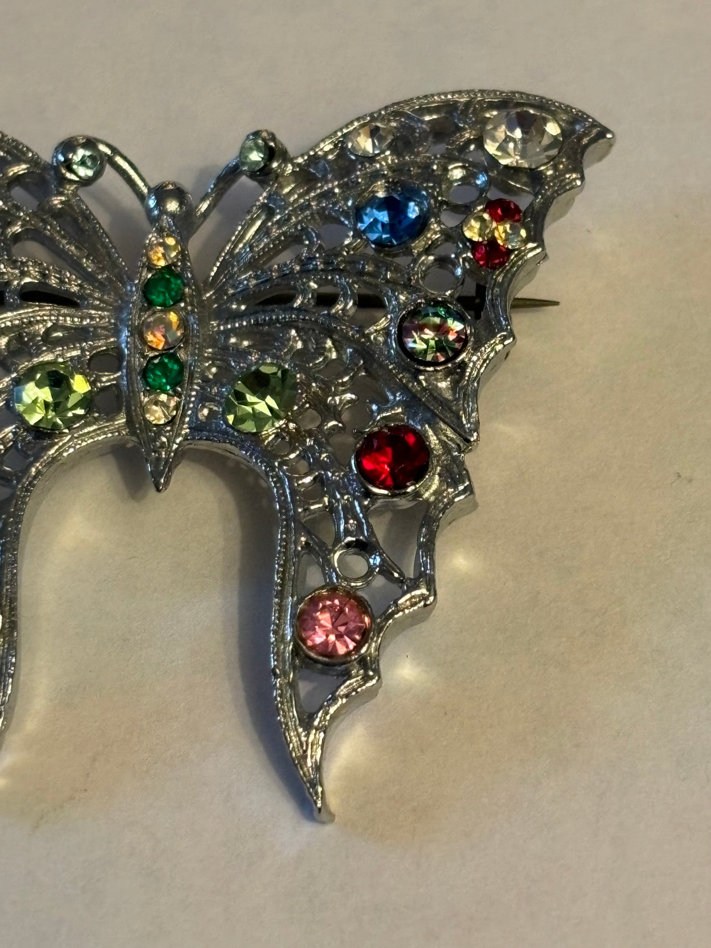 Large bright silver metal butterfly brooch with coloured stones