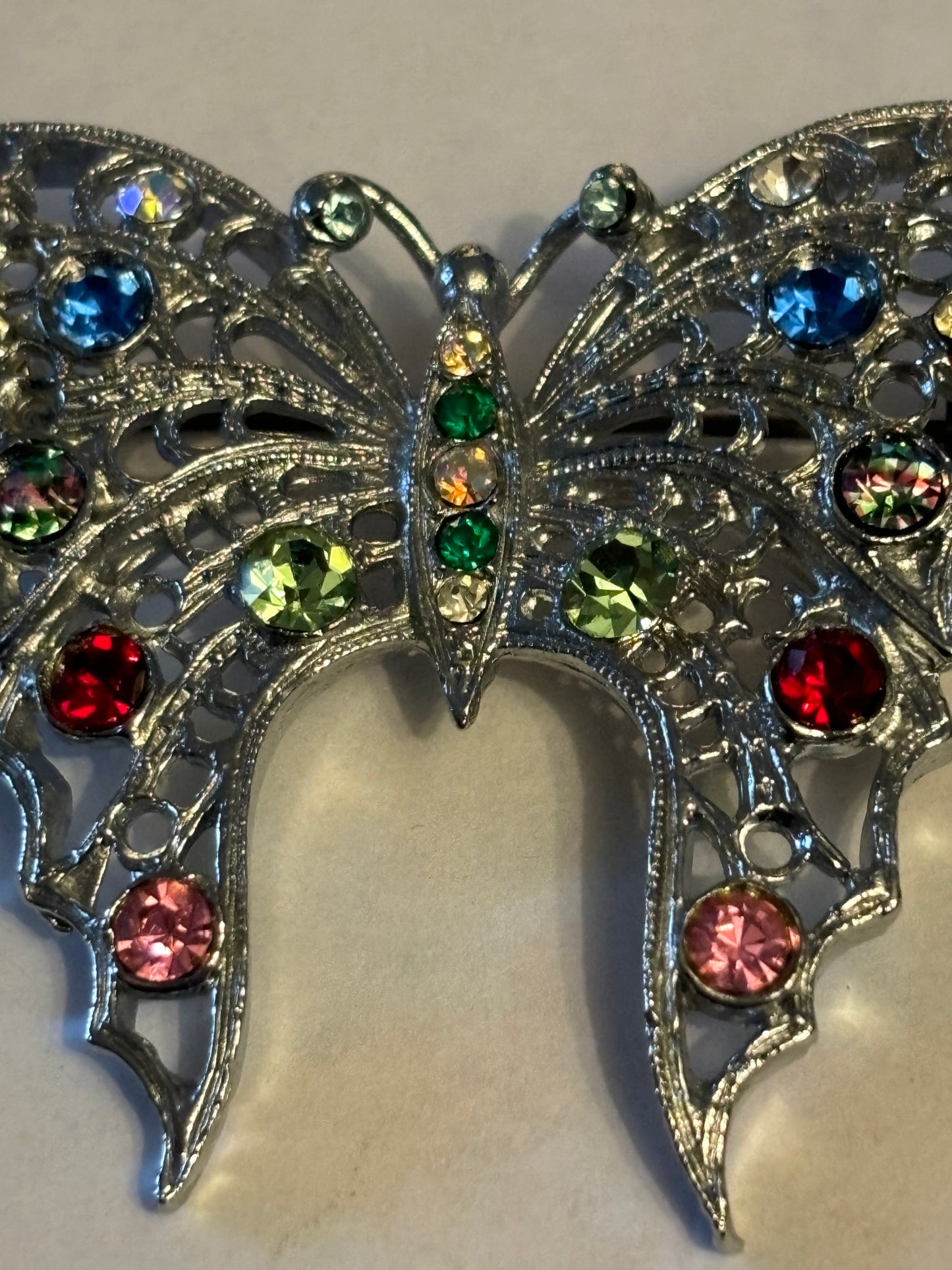 Large bright silver metal butterfly brooch with coloured stones