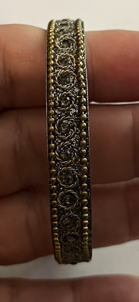 Silver patterned bangle, gold beading, silver sparkles etc.