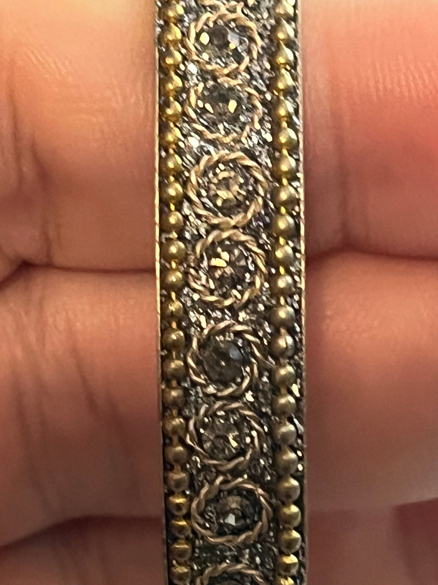 Silver patterned bangle, gold beading, silver sparkles etc.