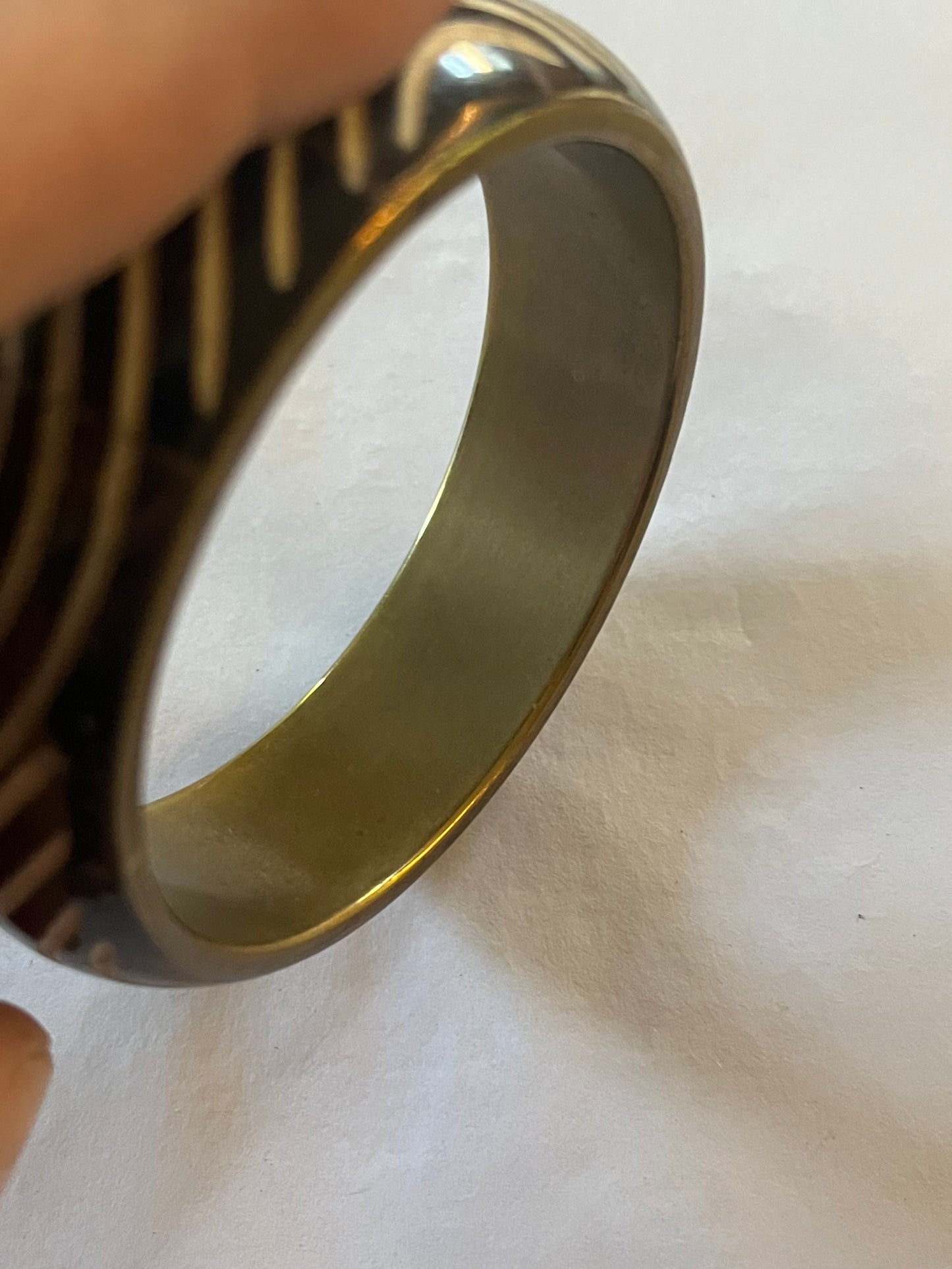 Metal bangle with black and white wavy pattern