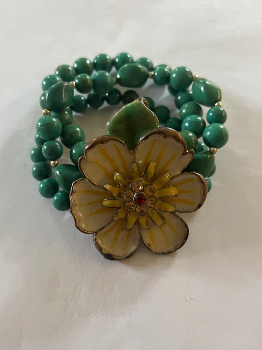 Triple turquoise bead bracelet with large white and yellow flower