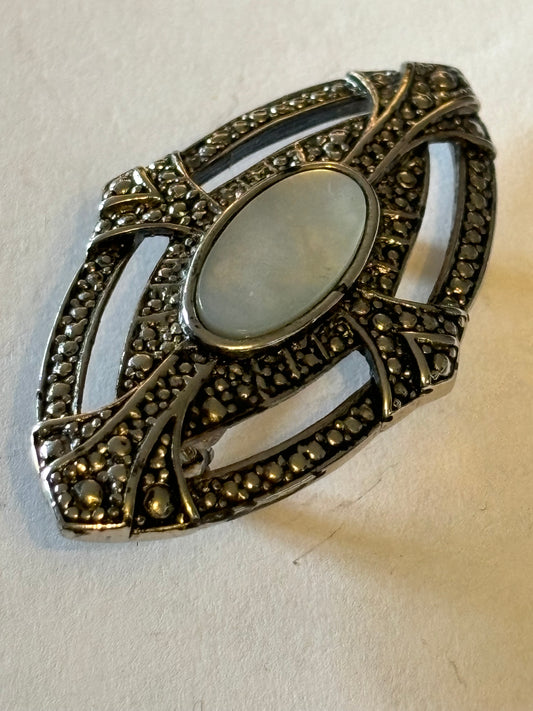 Oval silver Metal Textured Shield brooch with Pearlescent stone centre