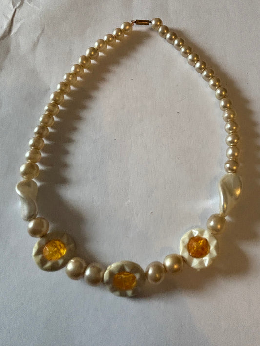 Pearlescent bead necklace with white discs and yellow centre