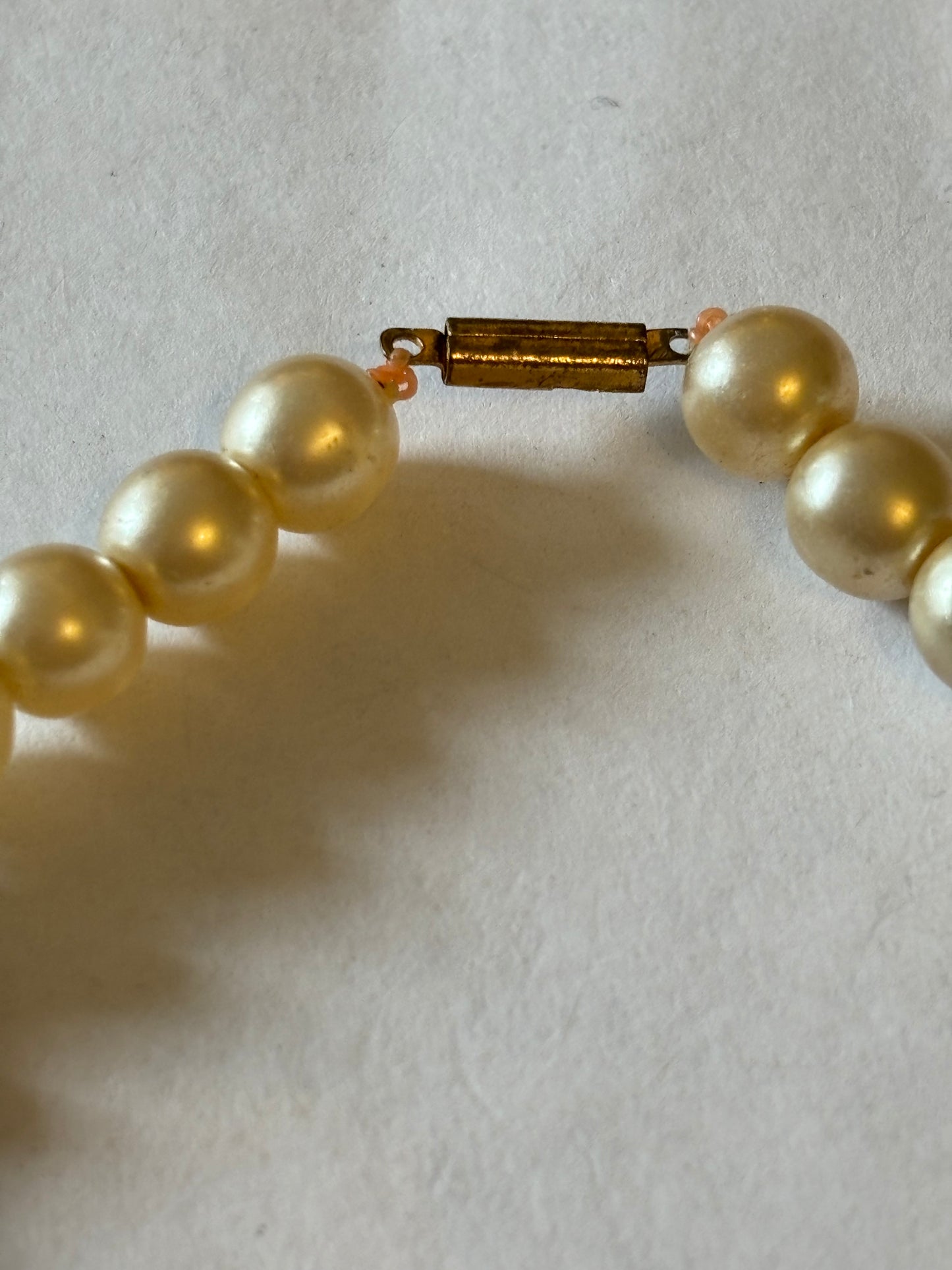 Pearlescent bead necklace with white discs and yellow centre