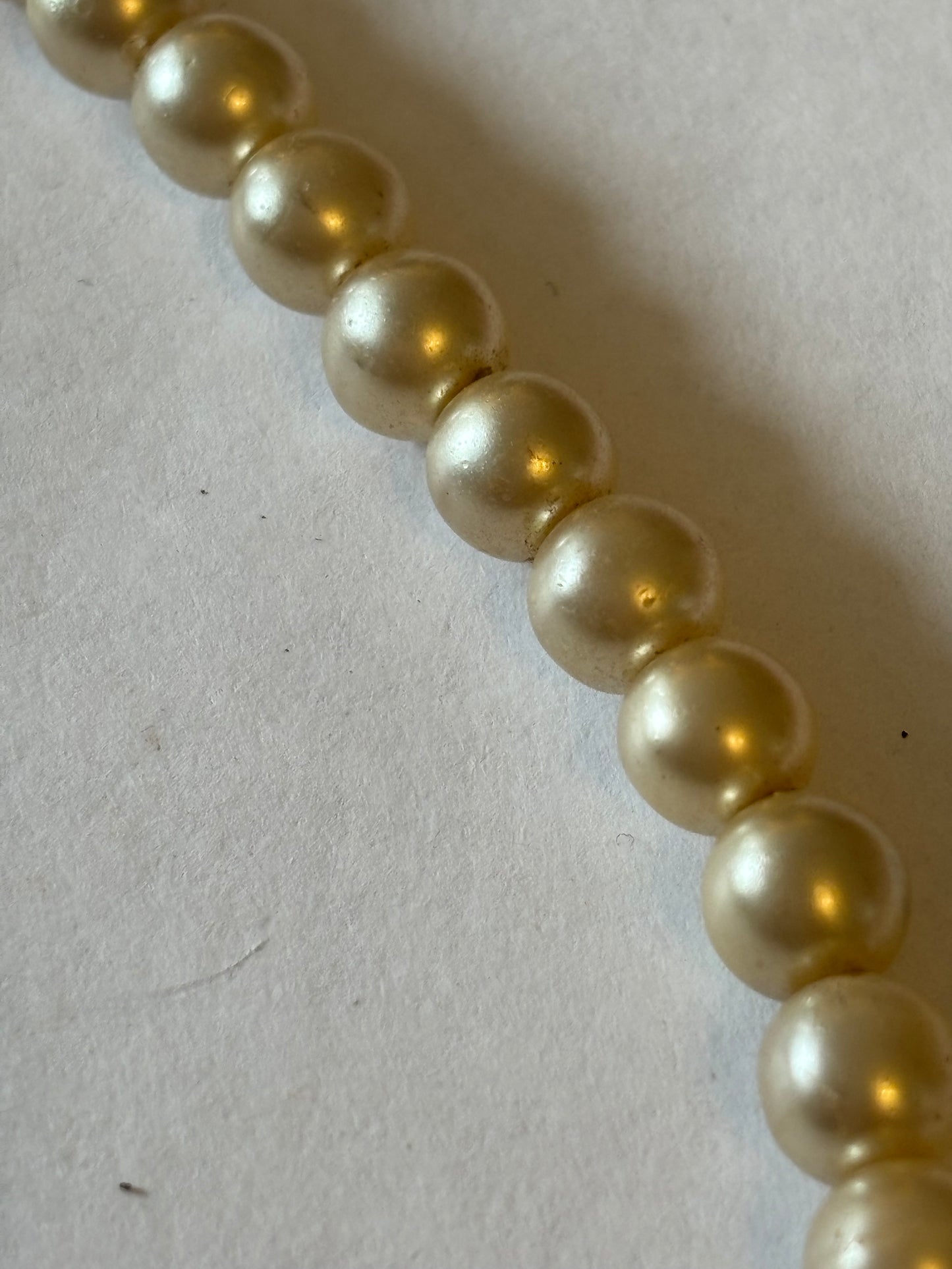 Pearlescent bead necklace with white discs and yellow centre