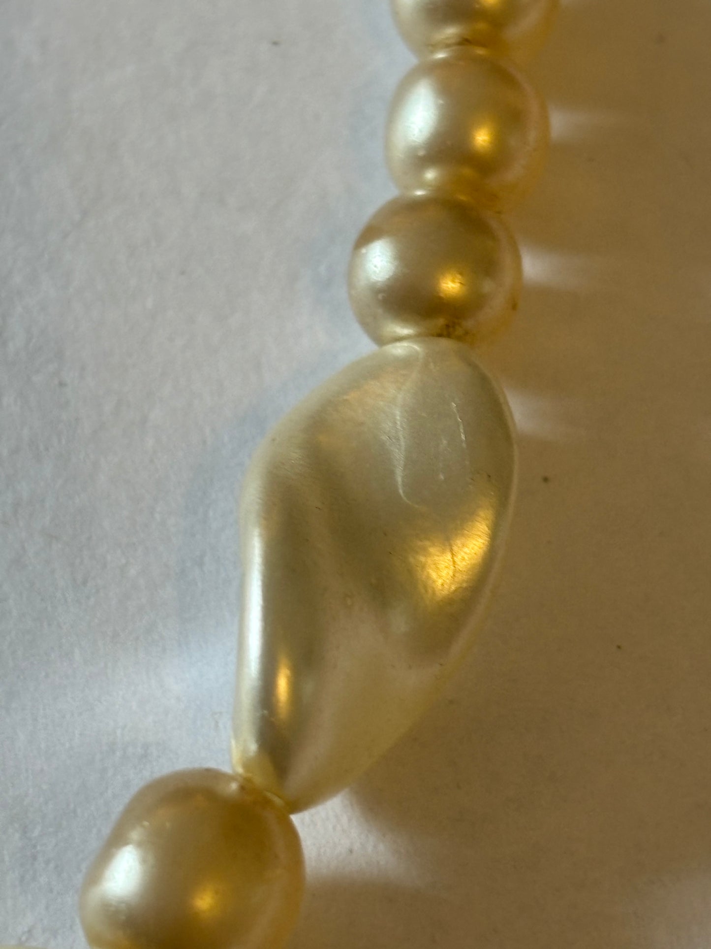 Pearlescent bead necklace with white discs and yellow centre