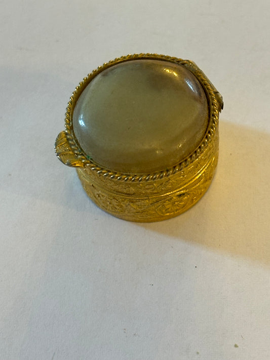 Small round gold decorative pill pot with stone lid