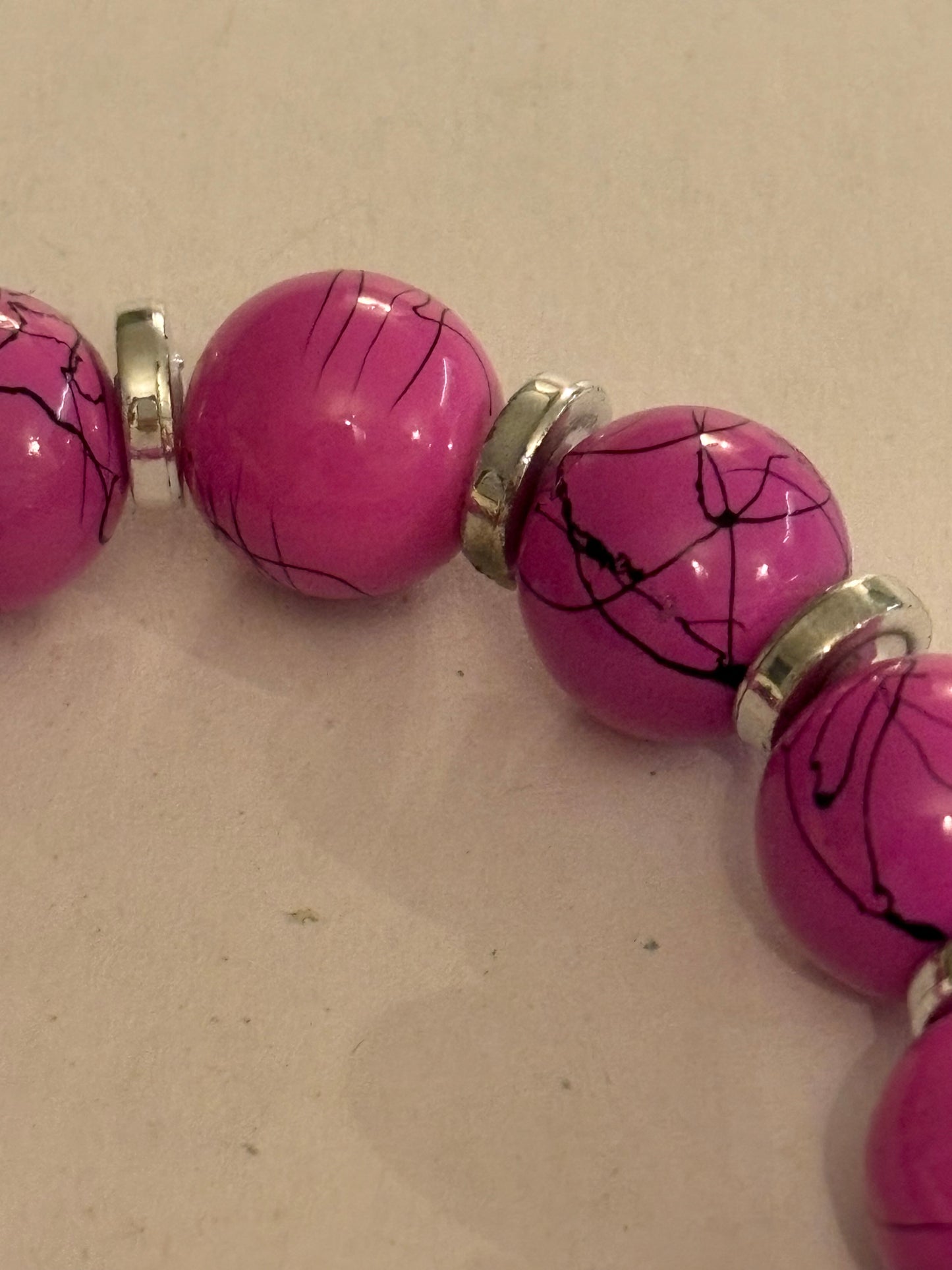 Pink cracked pattern bead stretch bracelet with silver disc spacers