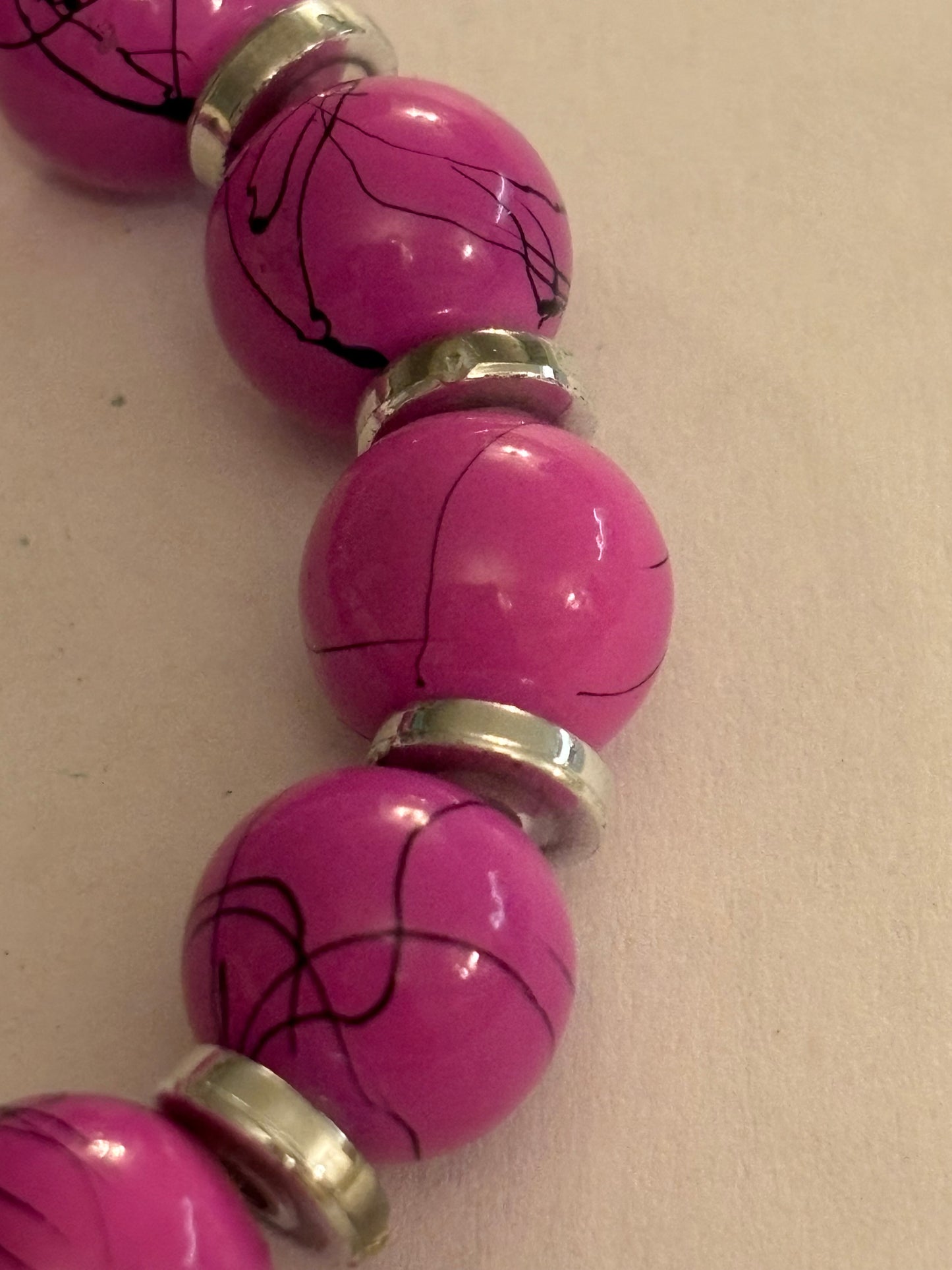 Pink cracked pattern bead stretch bracelet with silver disc spacers