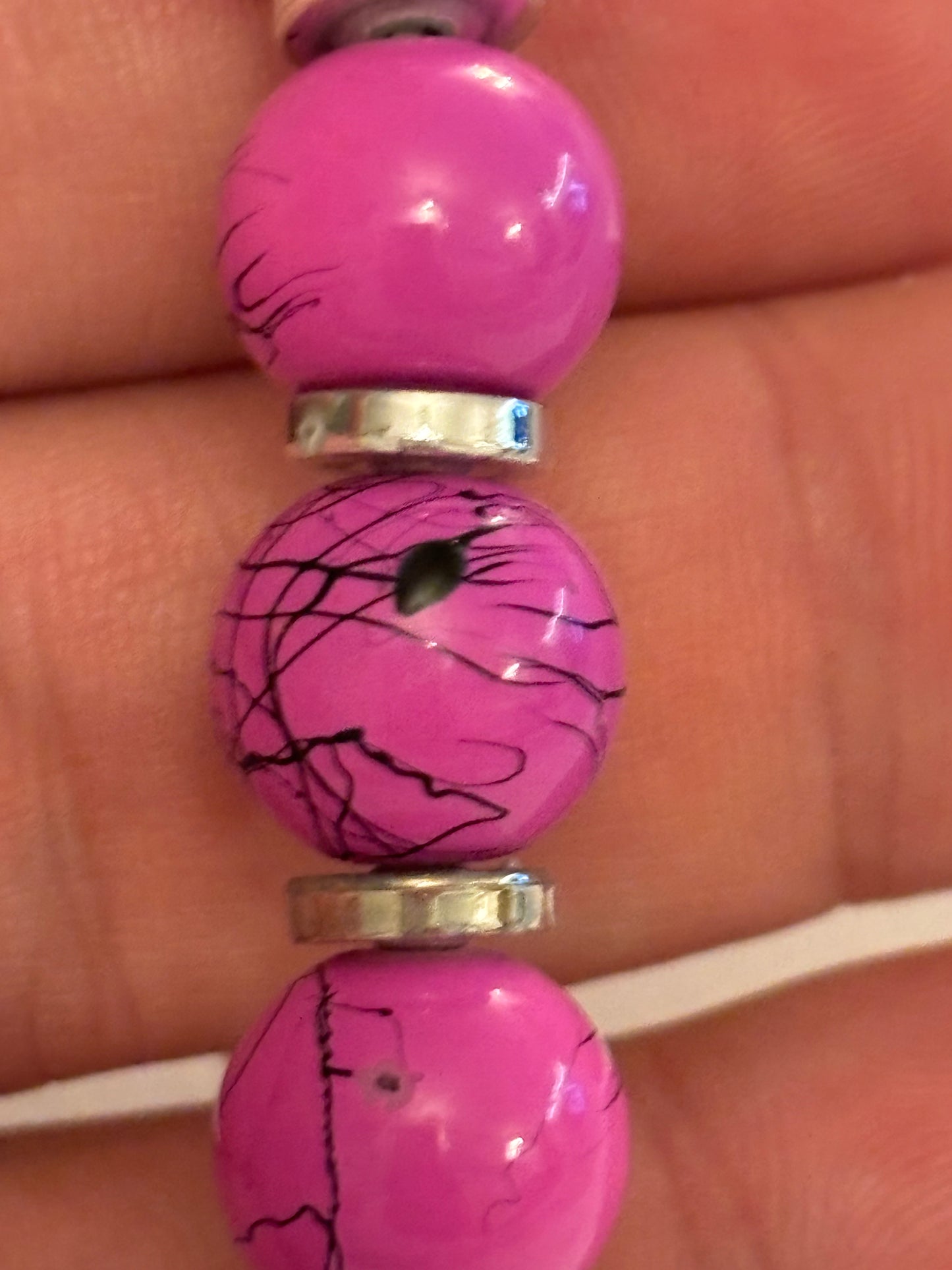 Pink cracked pattern bead stretch bracelet with silver disc spacers