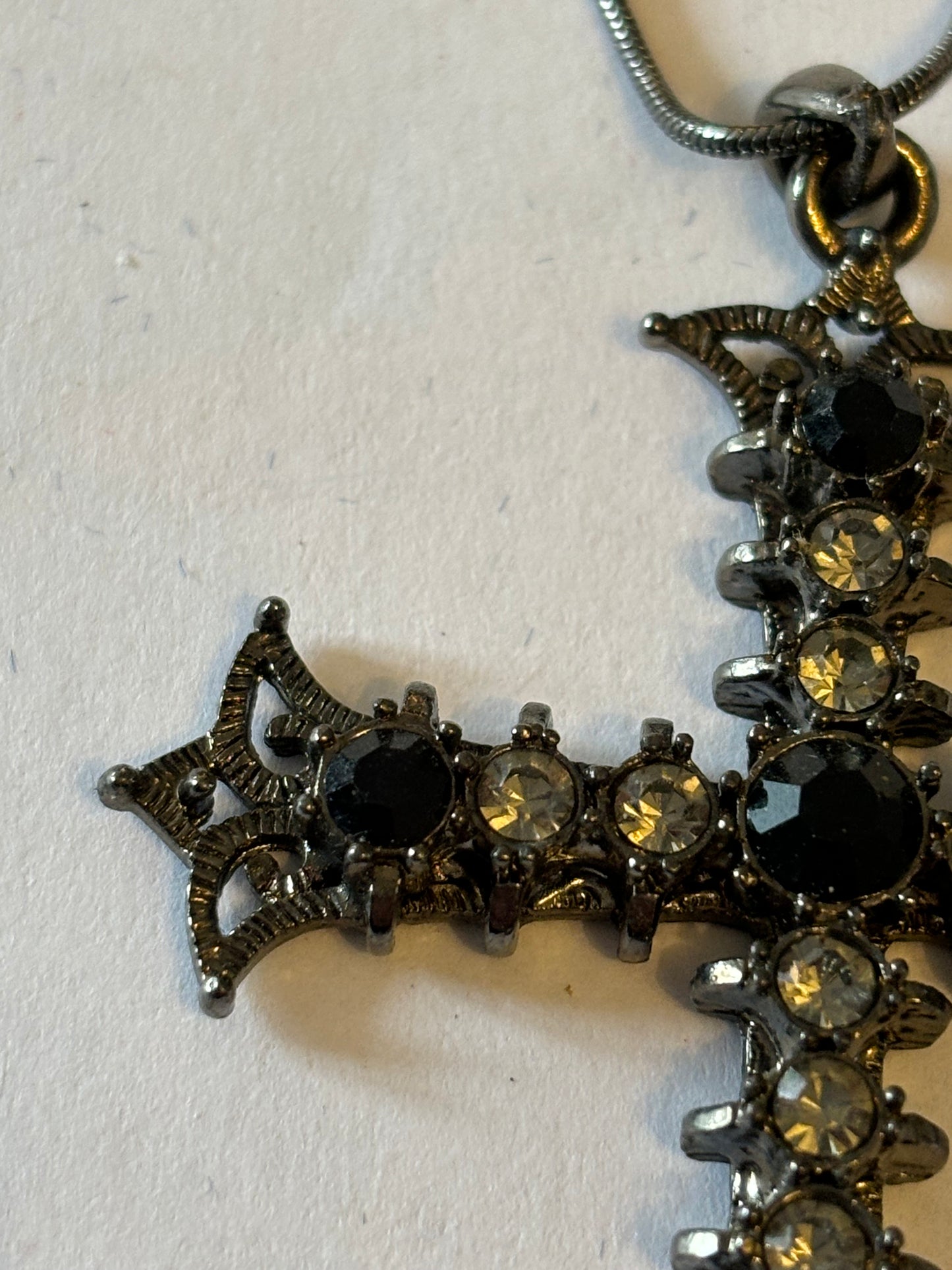 Dark metal smooth necklace with ornate jewelled cross pendant