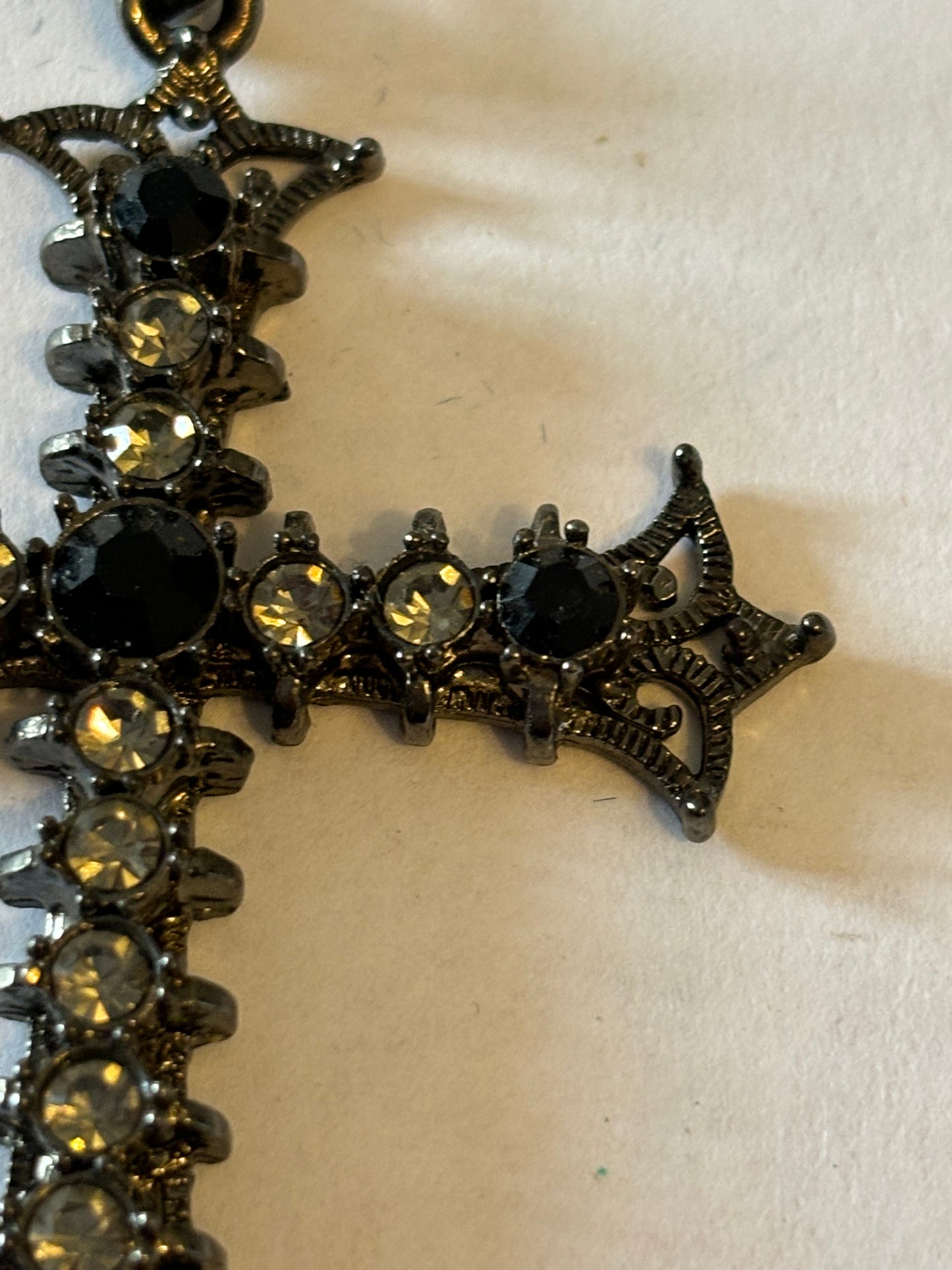 Dark metal smooth necklace with ornate jewelled cross pendant