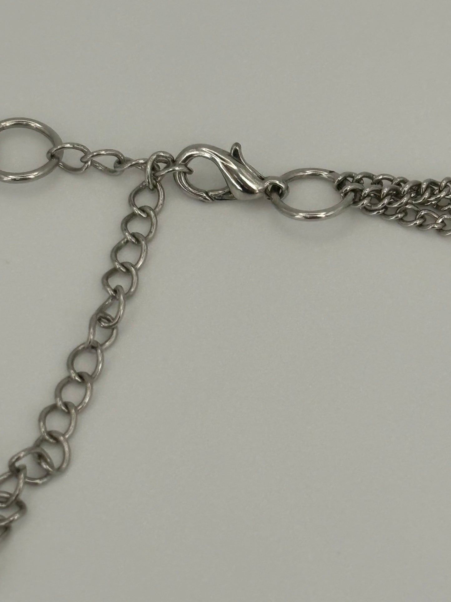 Triple silver chain necklace with heavy silver wire rings pendant