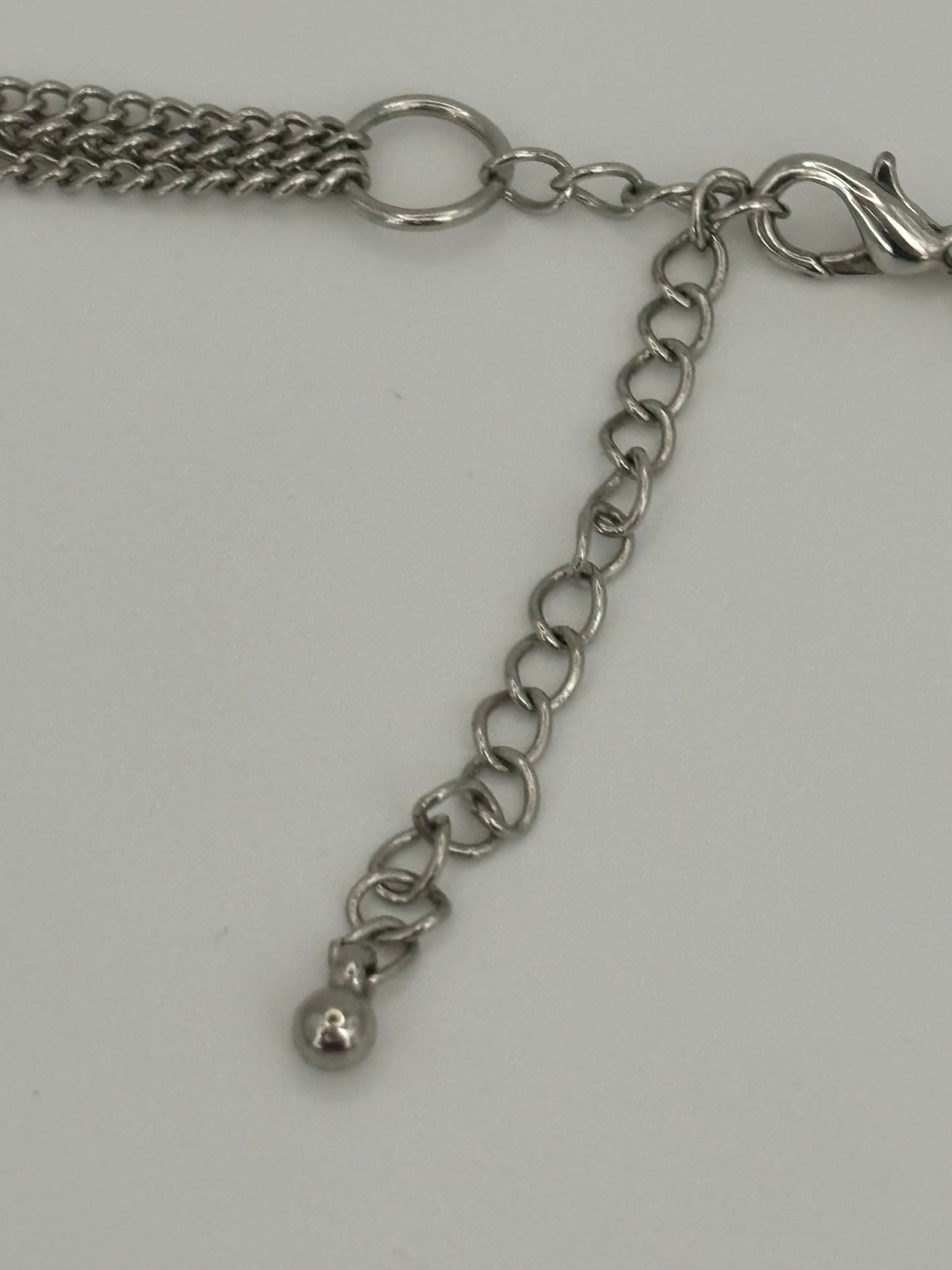 Triple silver chain necklace with heavy silver wire rings pendant