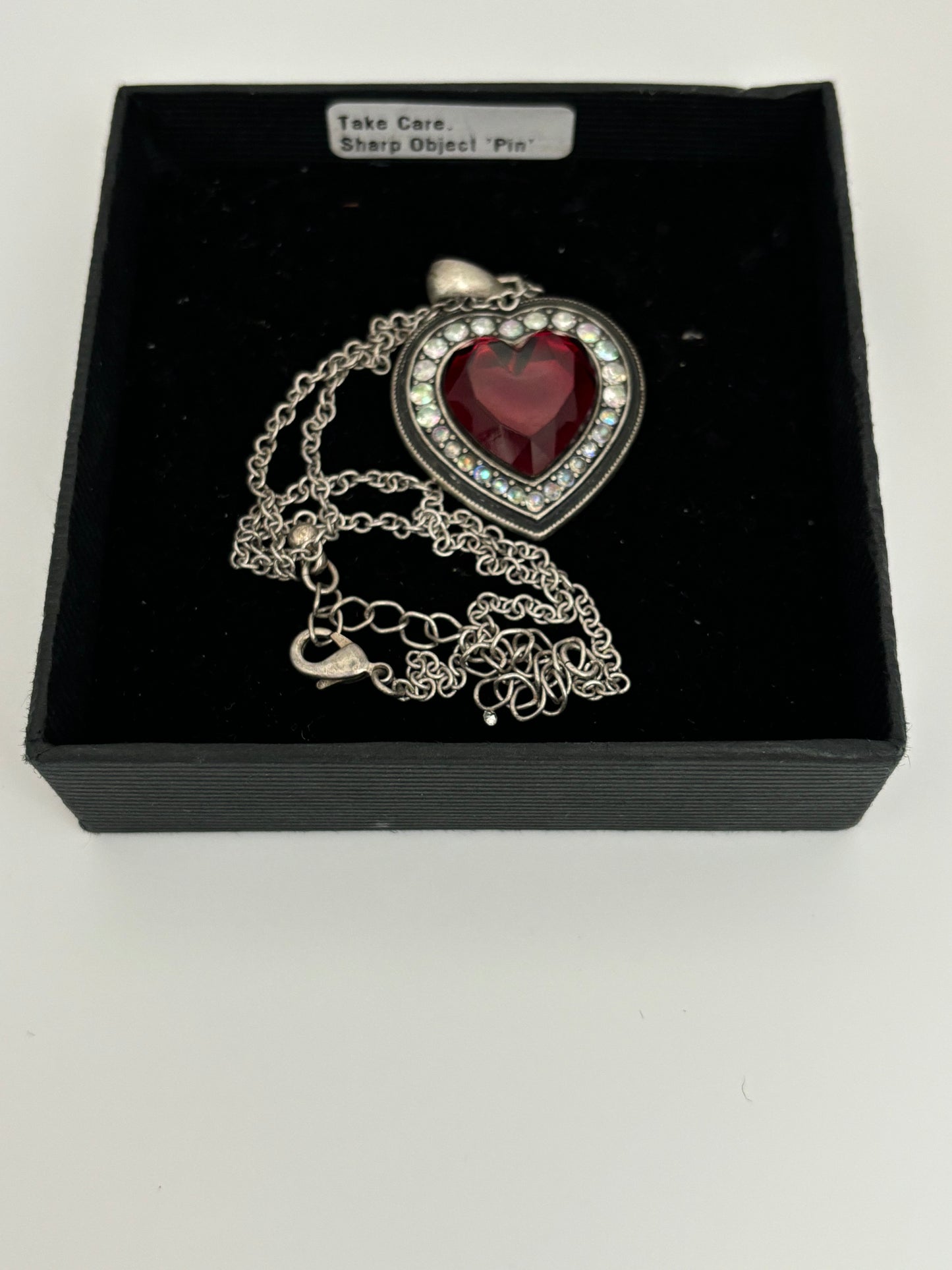 Silver necklace with red stone heart pendant