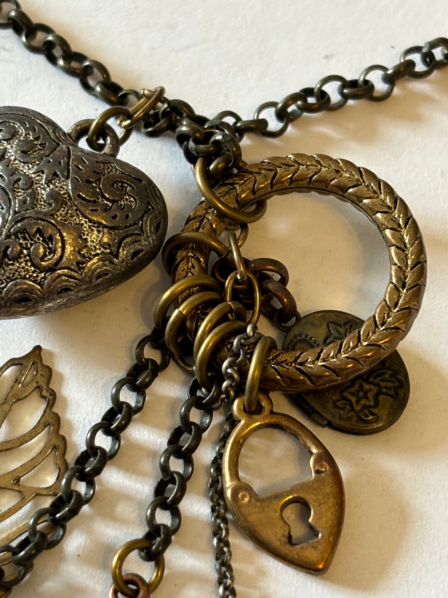 Vintage style bronzey coloured necklace with heart, leaf and padlock pendant