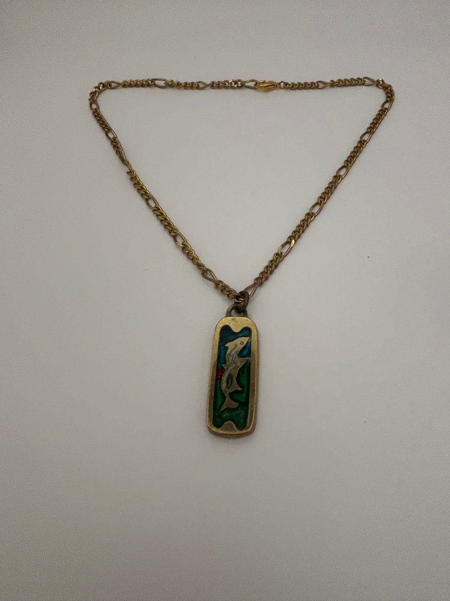 Gold metal necklace with ingot style Dolphin and coloured stone pendant