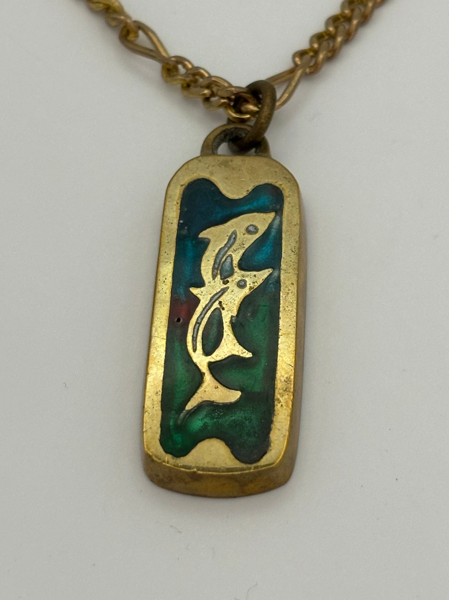 Gold metal necklace with ingot style Dolphin and coloured stone pendant