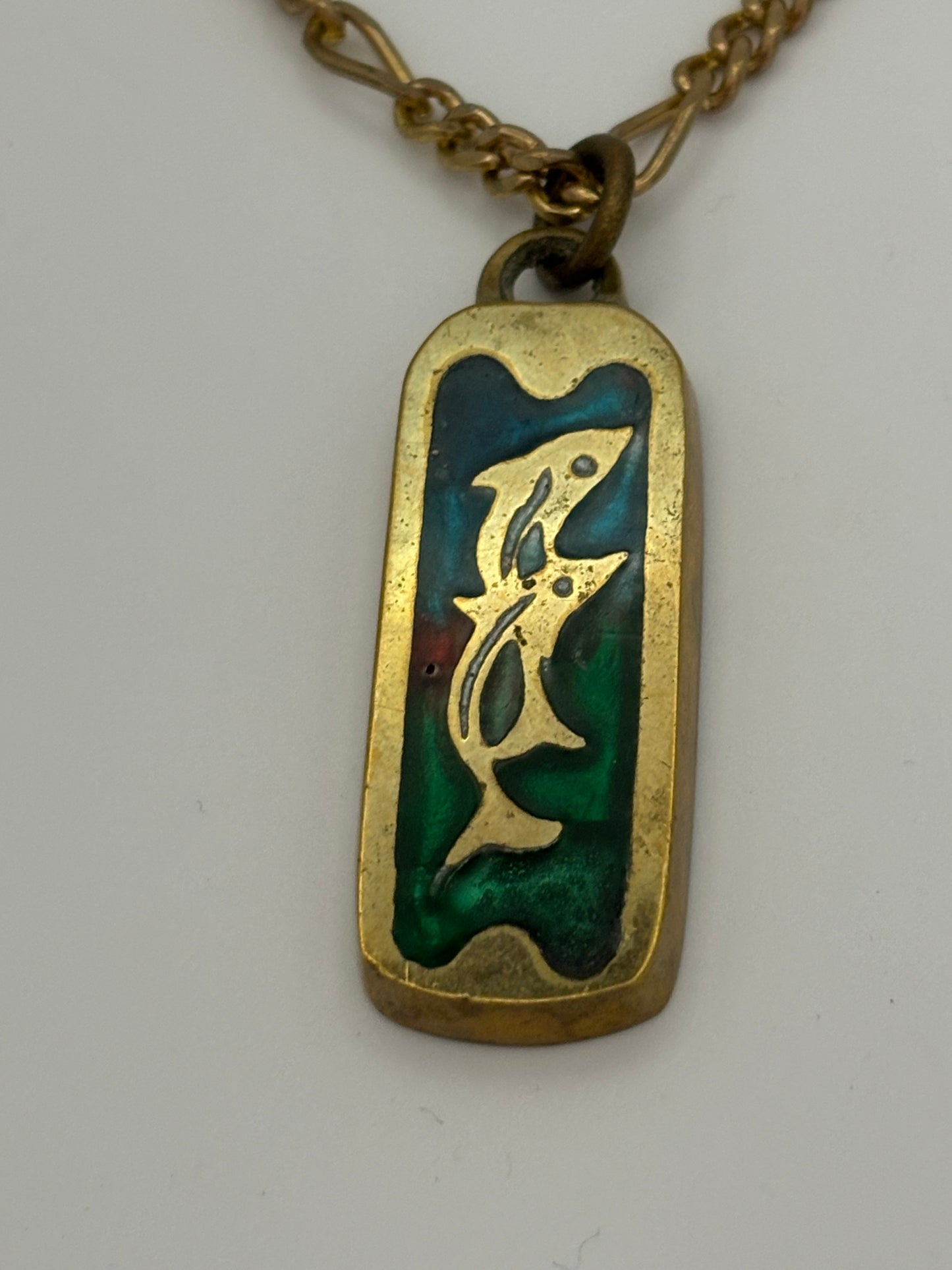 Gold metal necklace with ingot style Dolphin and coloured stone pendant