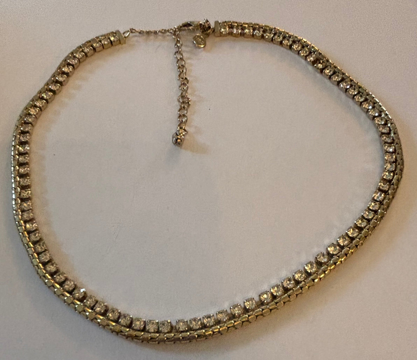 Gold chain necklace with a fringe of white stones