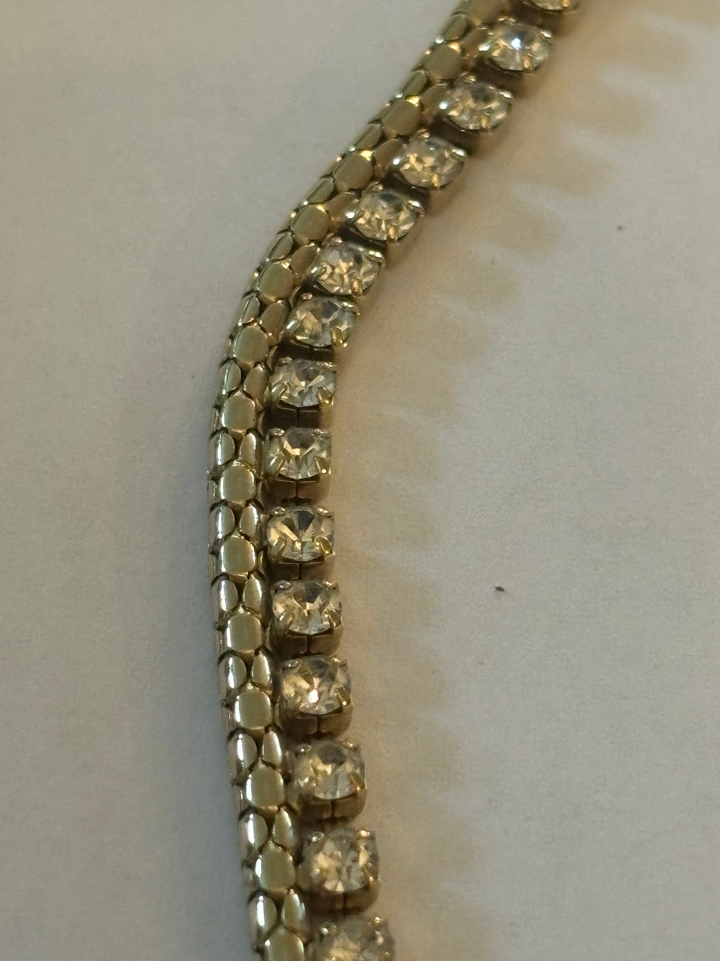 Gold chain necklace with a fringe of white stones