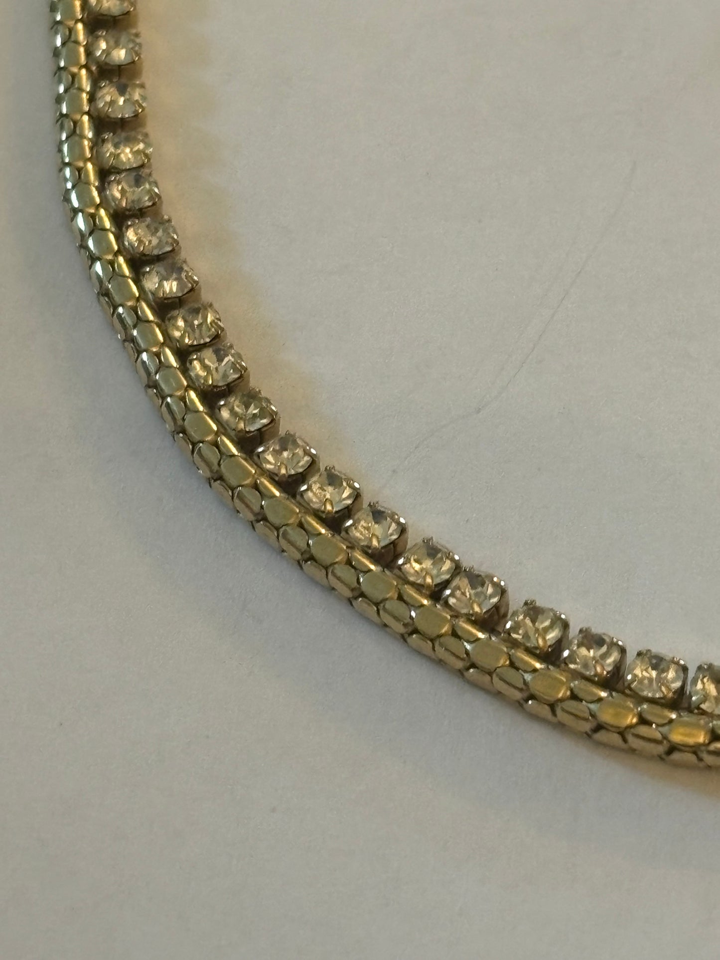 Gold chain necklace with a fringe of white stones