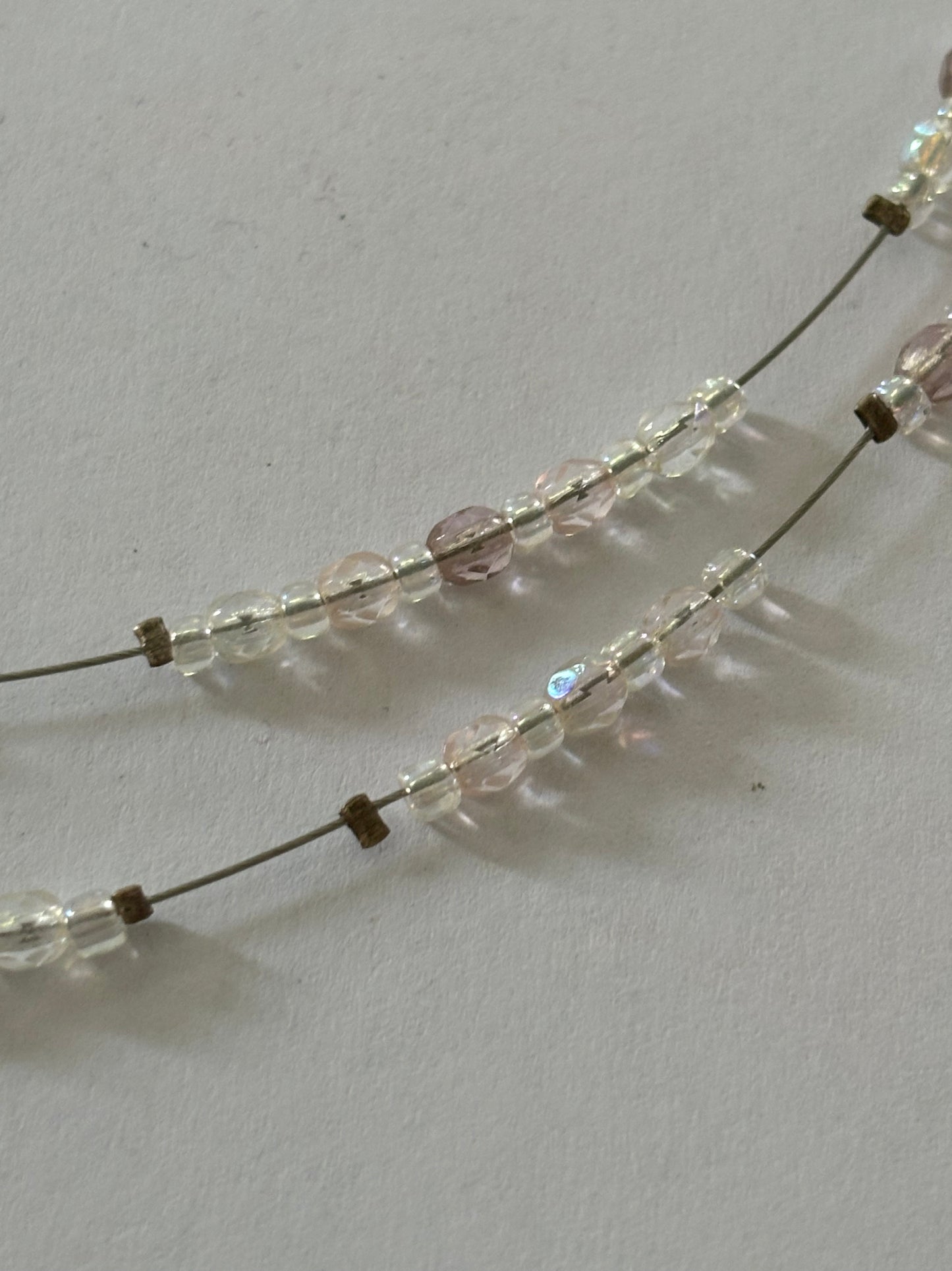 Double silver wire necklace with sliding small clear beads