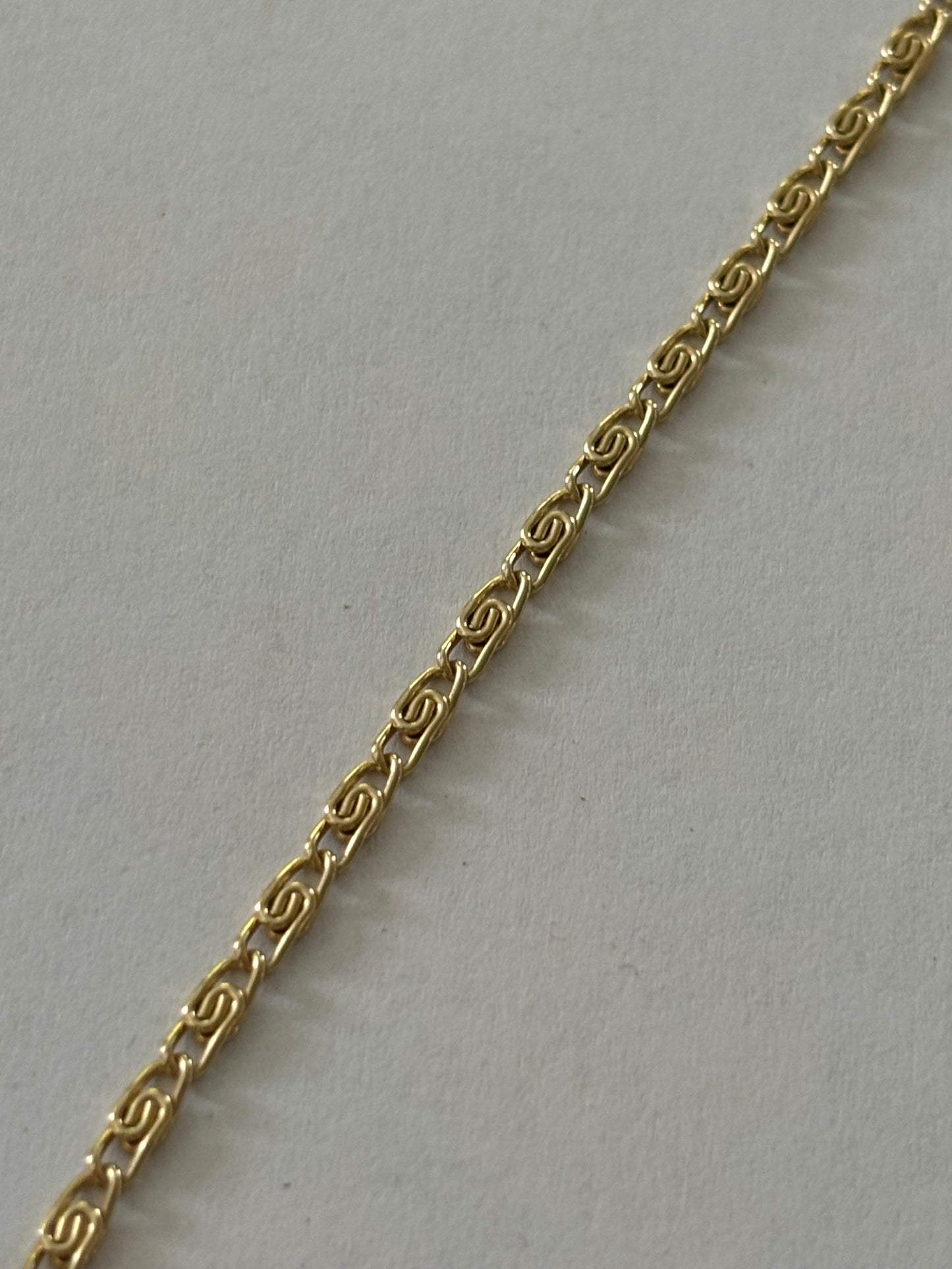 Gold metal chain necklace with V bar pendant of pearlescent beads