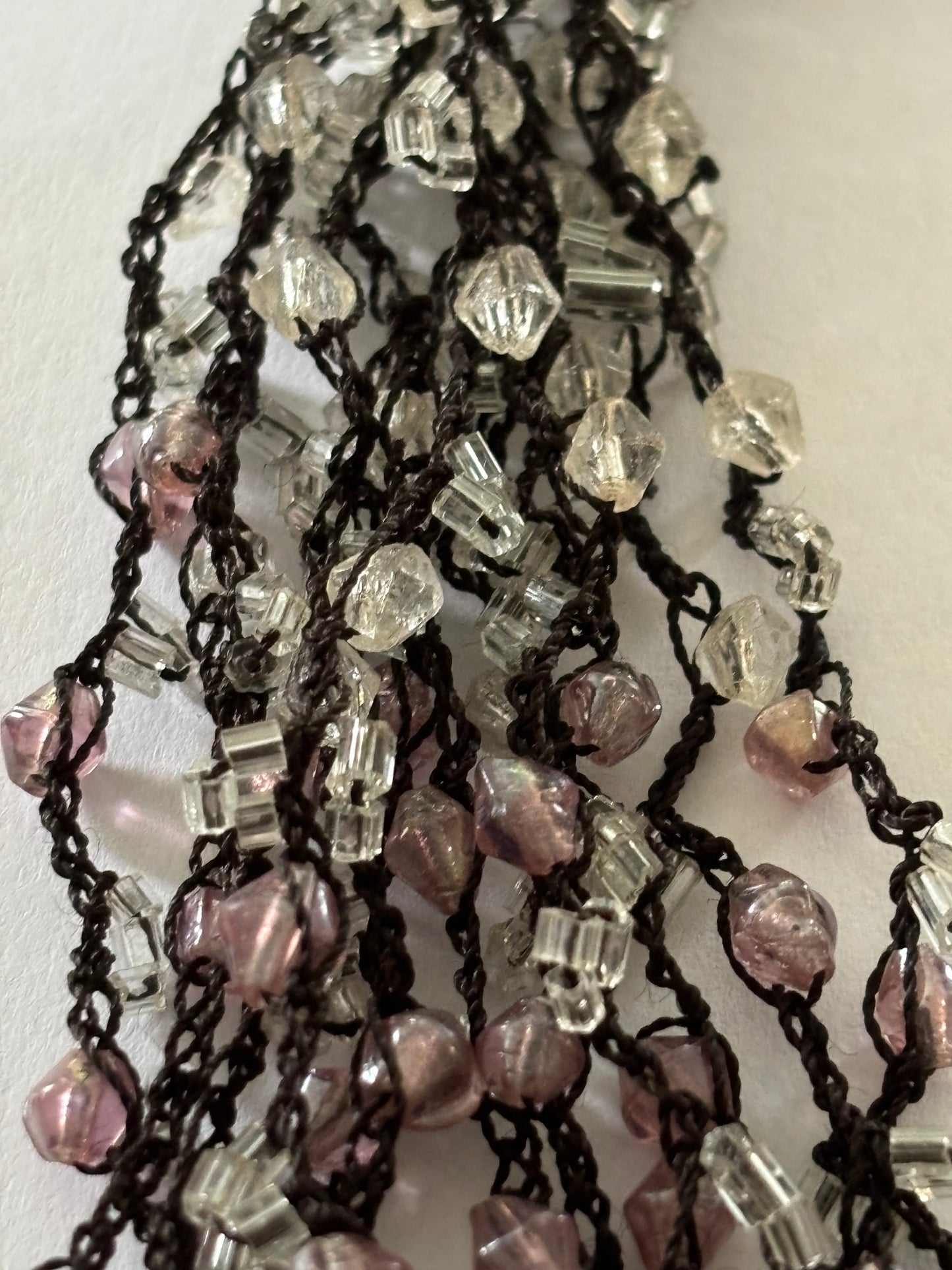 Dark metal cluster necklace of small pink/lilac and clear beads