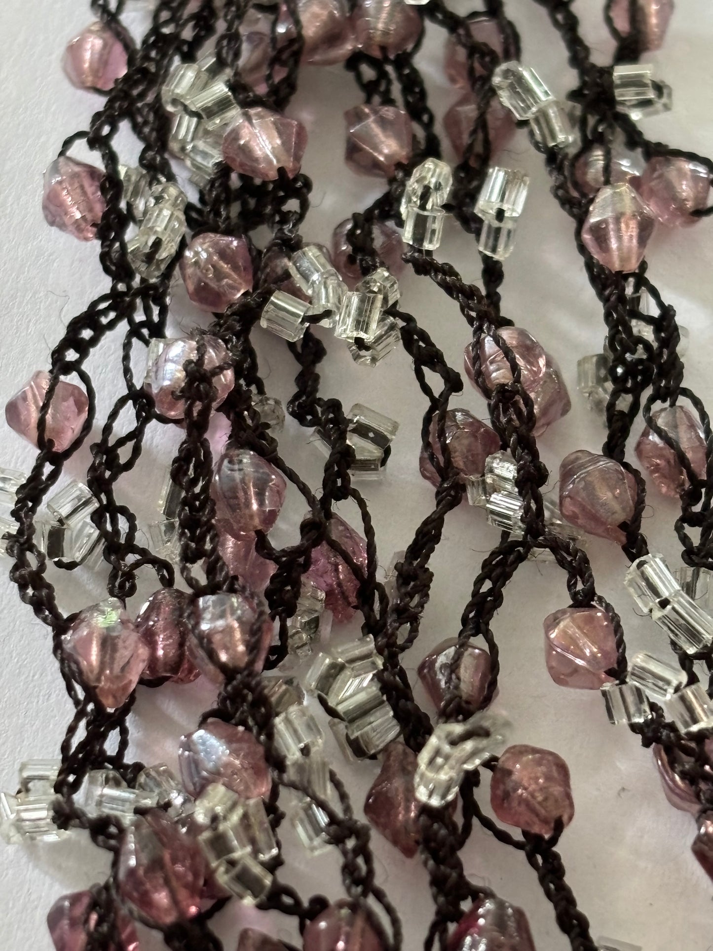 Dark metal cluster necklace of small pink/lilac and clear beads