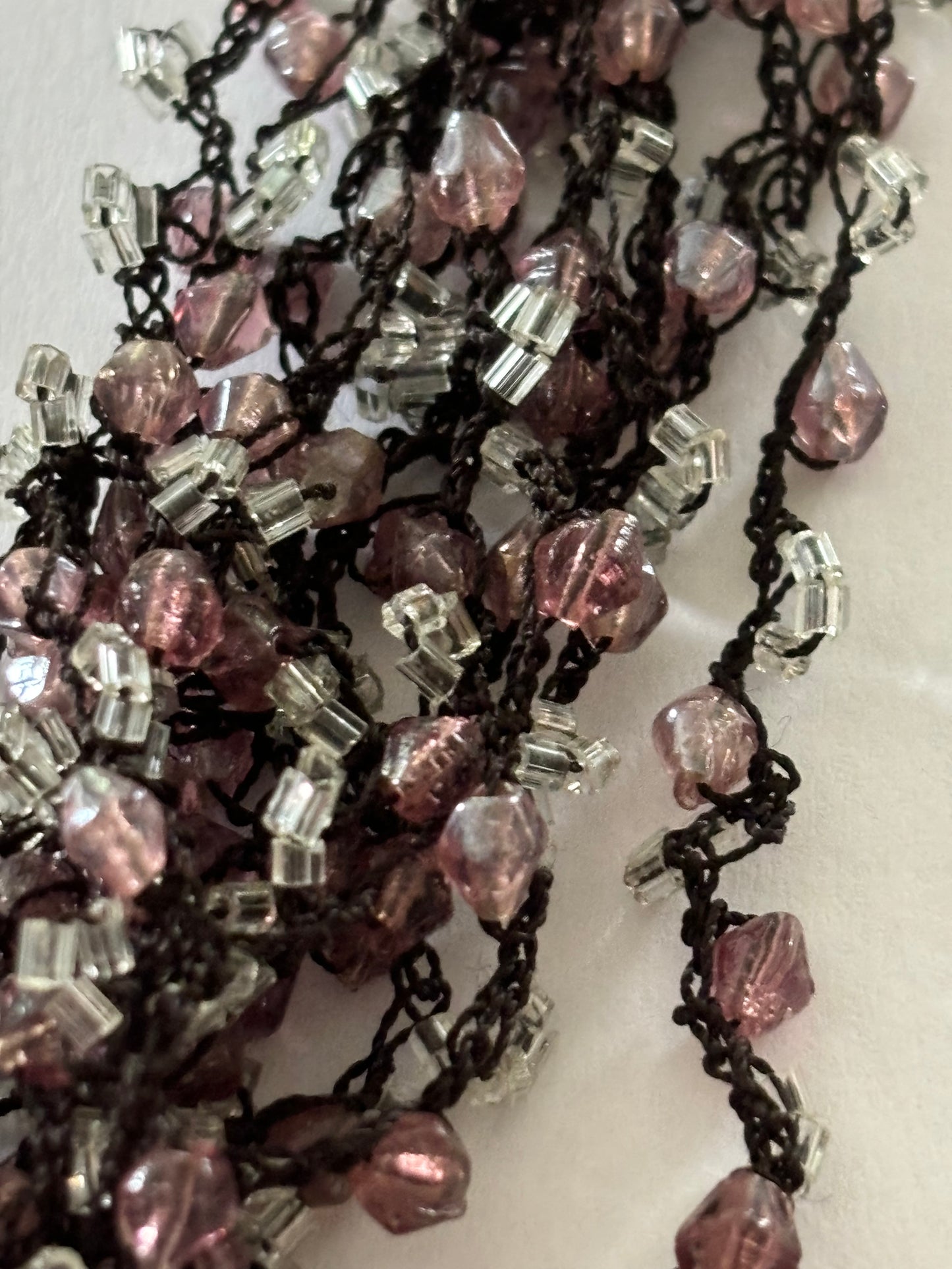 Dark metal cluster necklace of small pink/lilac and clear beads