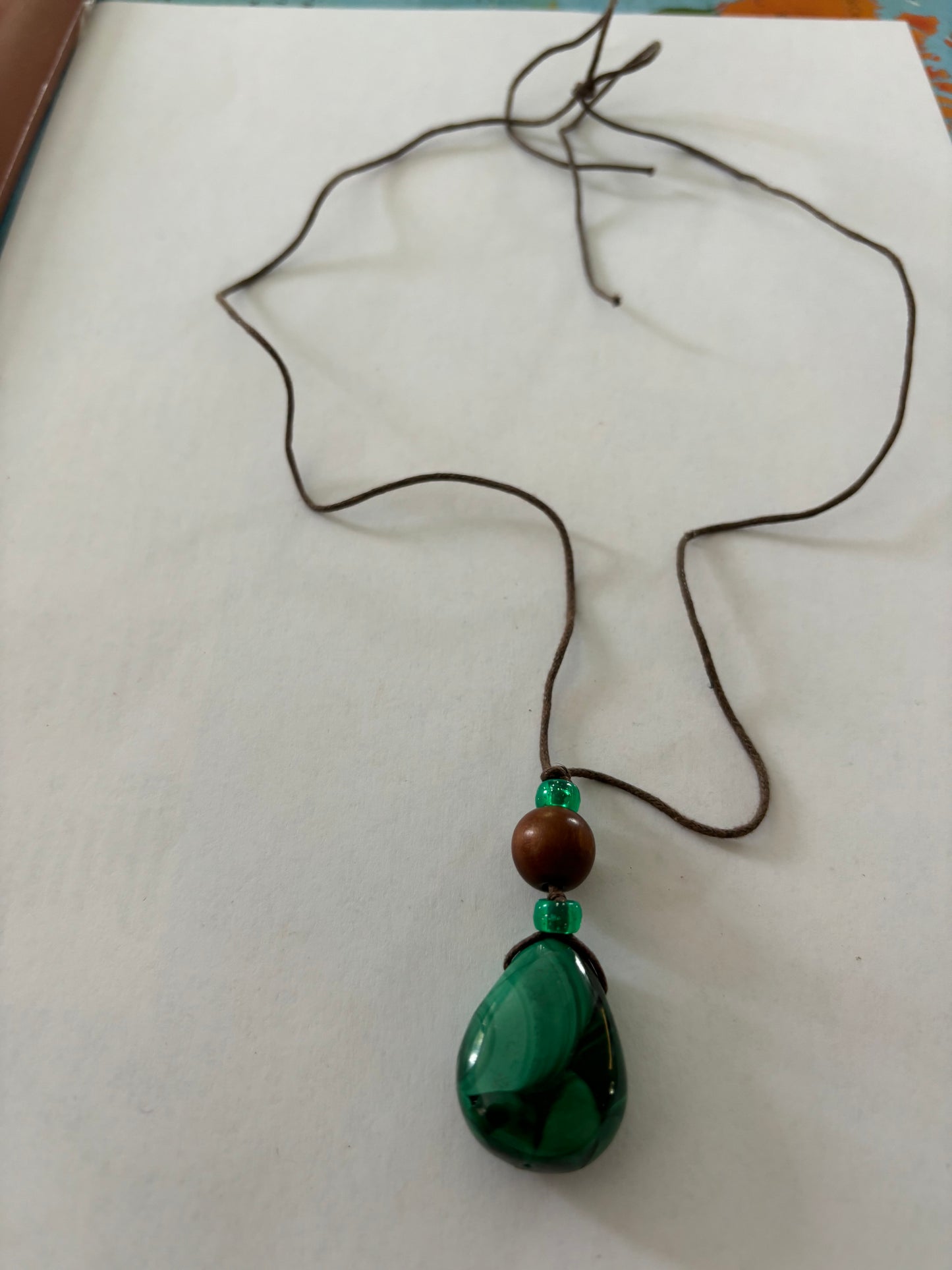 Brown string necklace with peardrop green marbled bead pendant