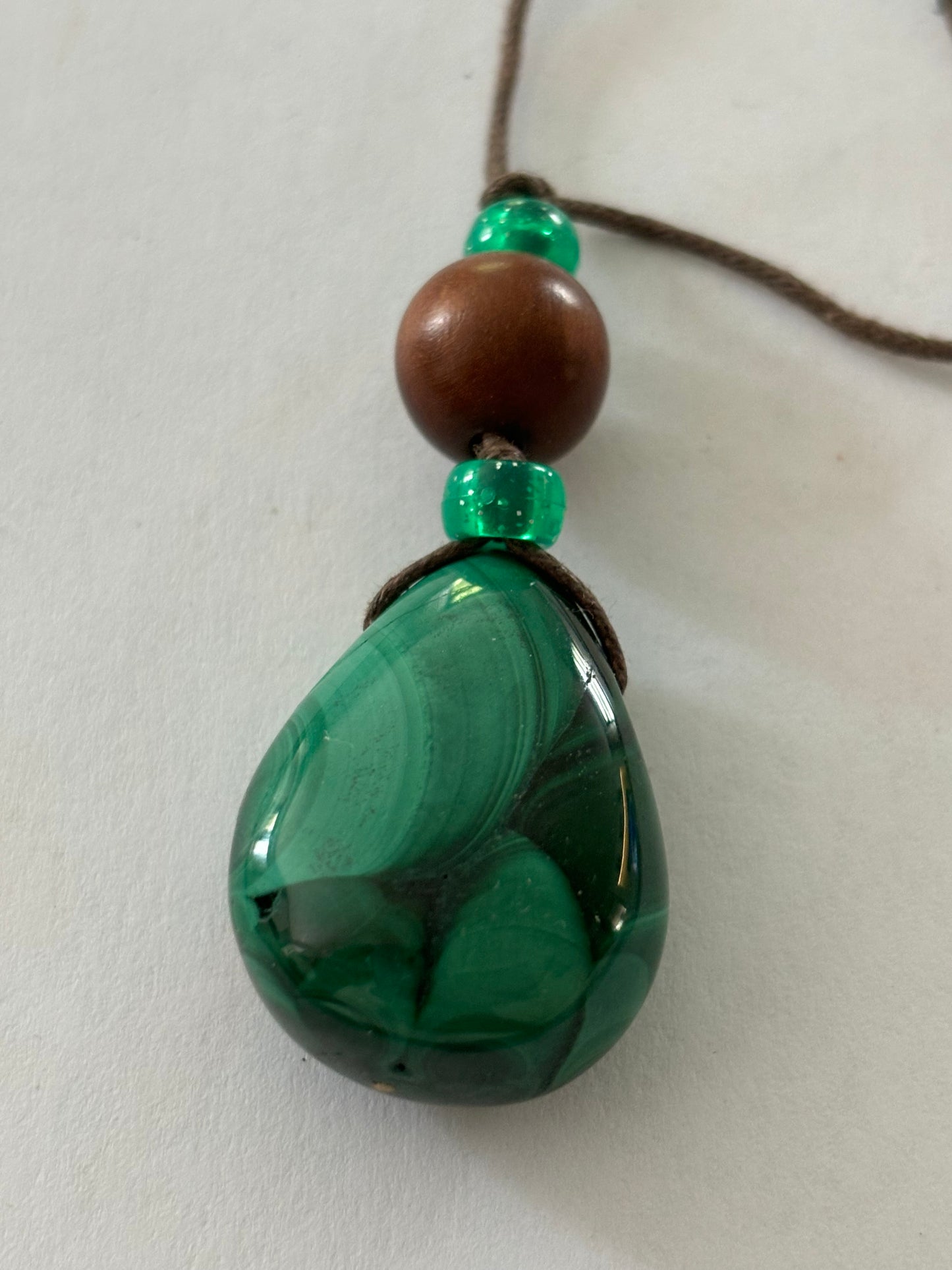 Brown string necklace with peardrop green marbled bead pendant