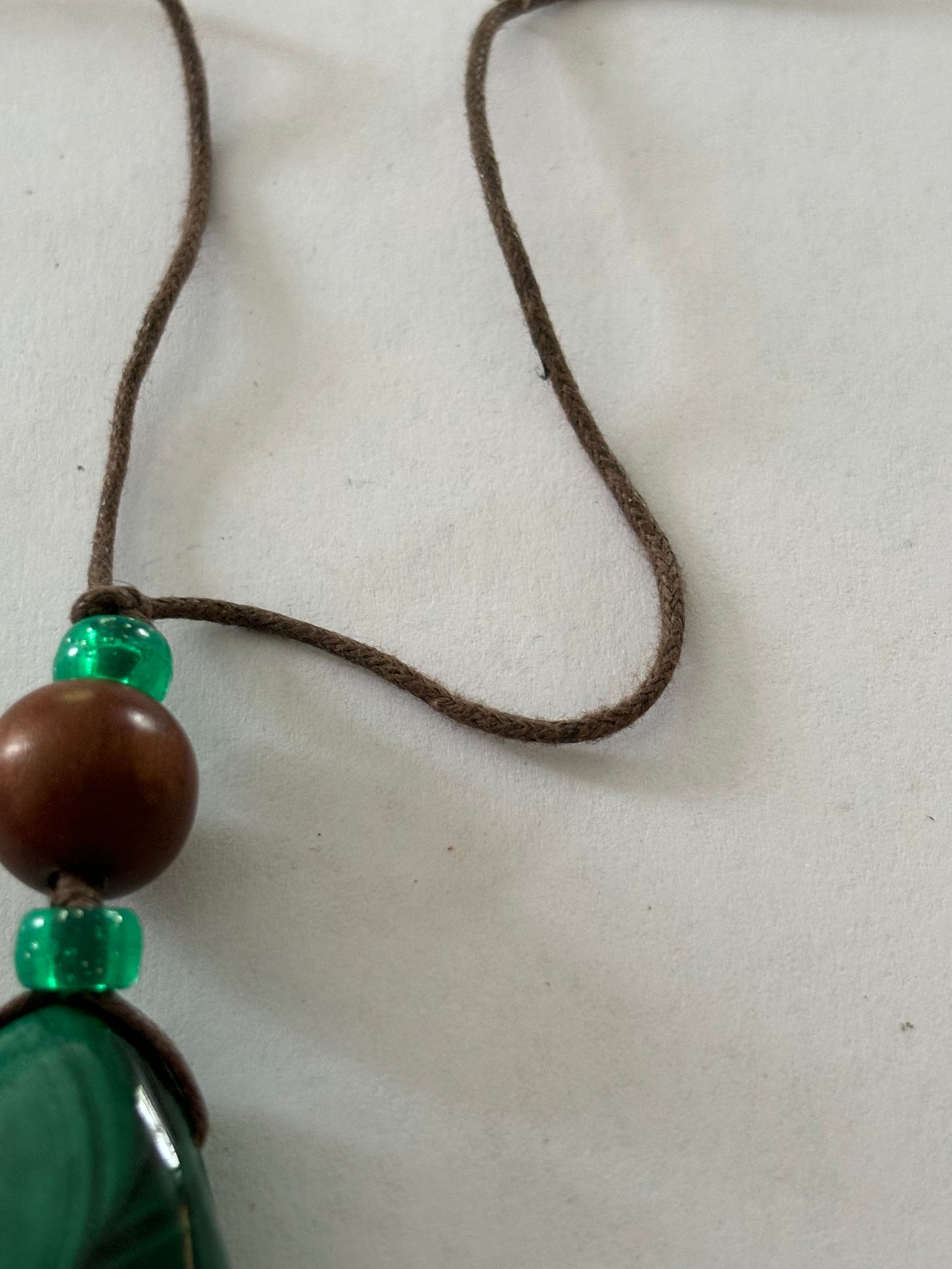 Brown string necklace with peardrop green marbled bead pendant