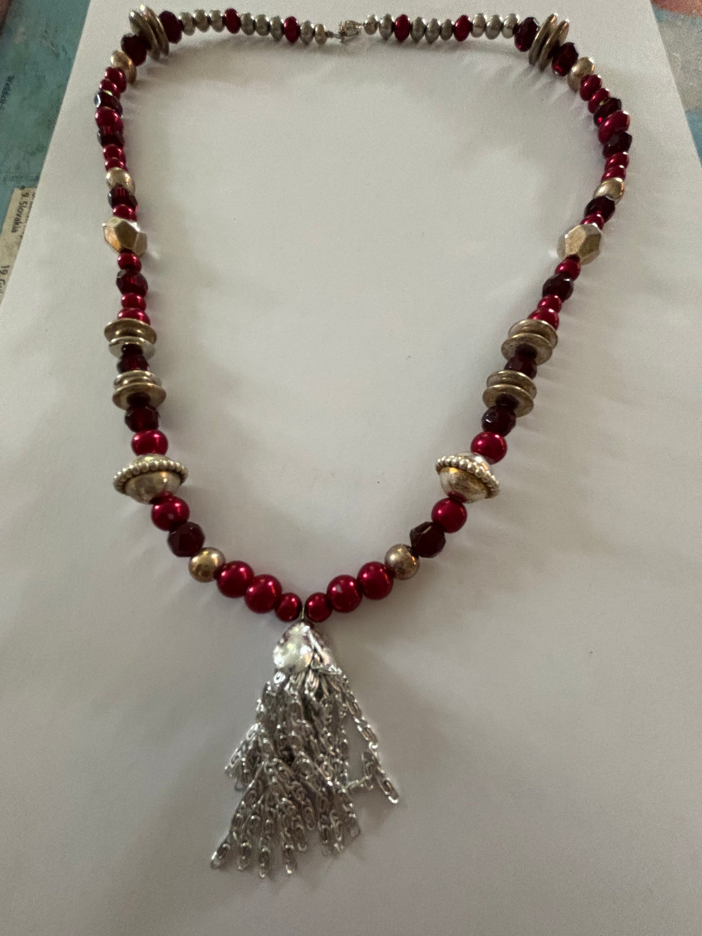 Red, gold and silver bead necklace with silver tassle